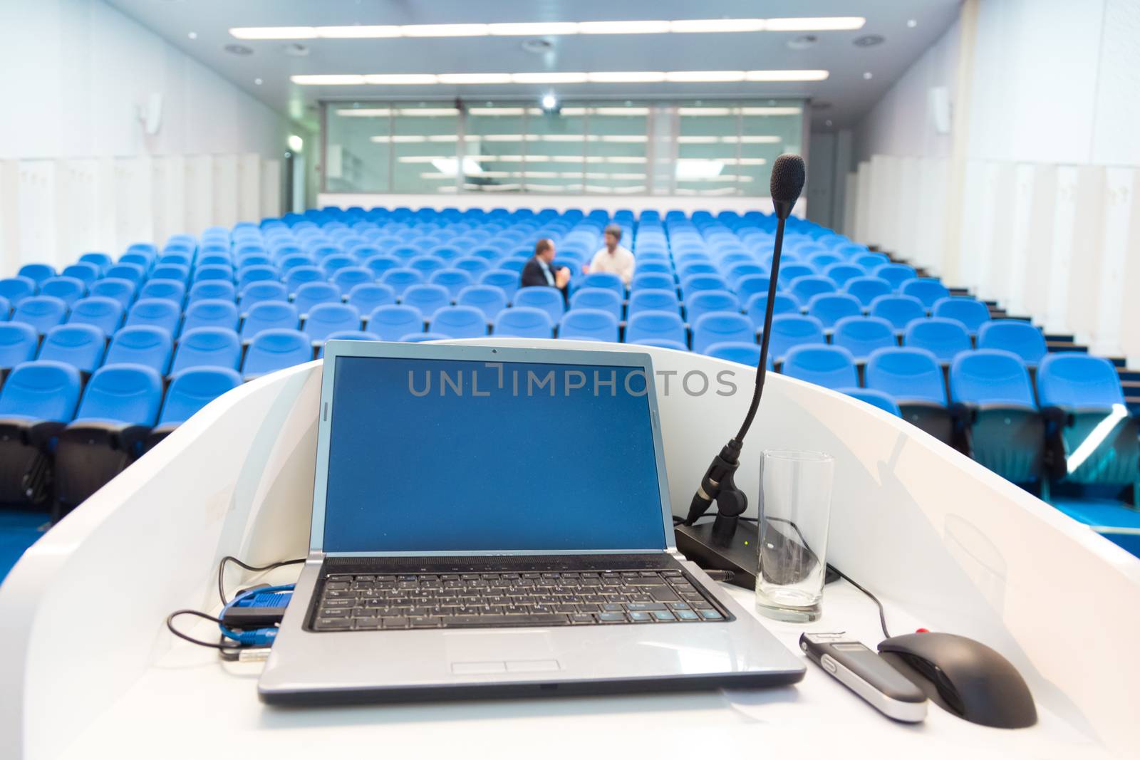 Laptop on the rostrum in conference hall. by kasto