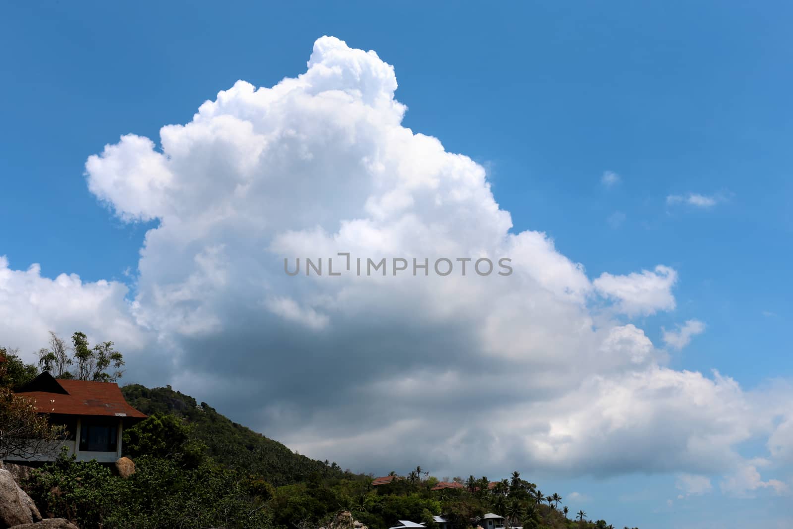 Big white cloud over the mountain on a blue sky