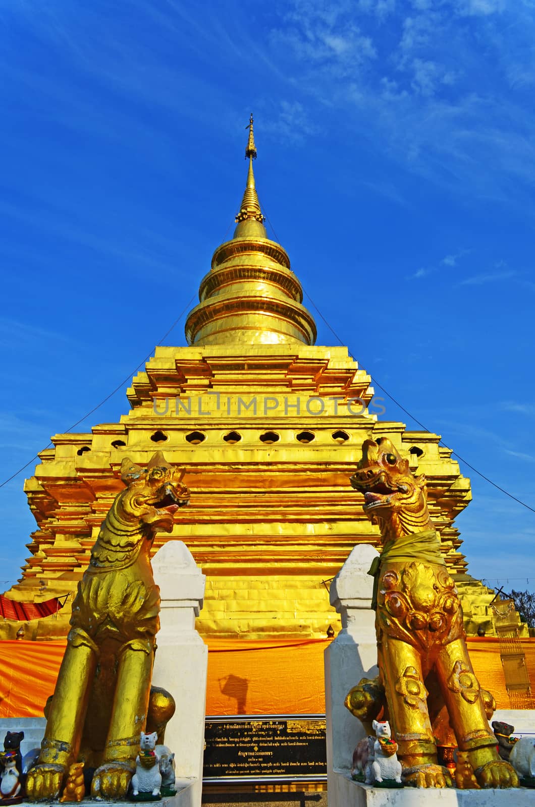 Phra That Sri Jom Thong, Series 1_3, Golden Pagoda with Cloud, Blue Sky and Stone Lion.Chiang Mai province,Thailand.
