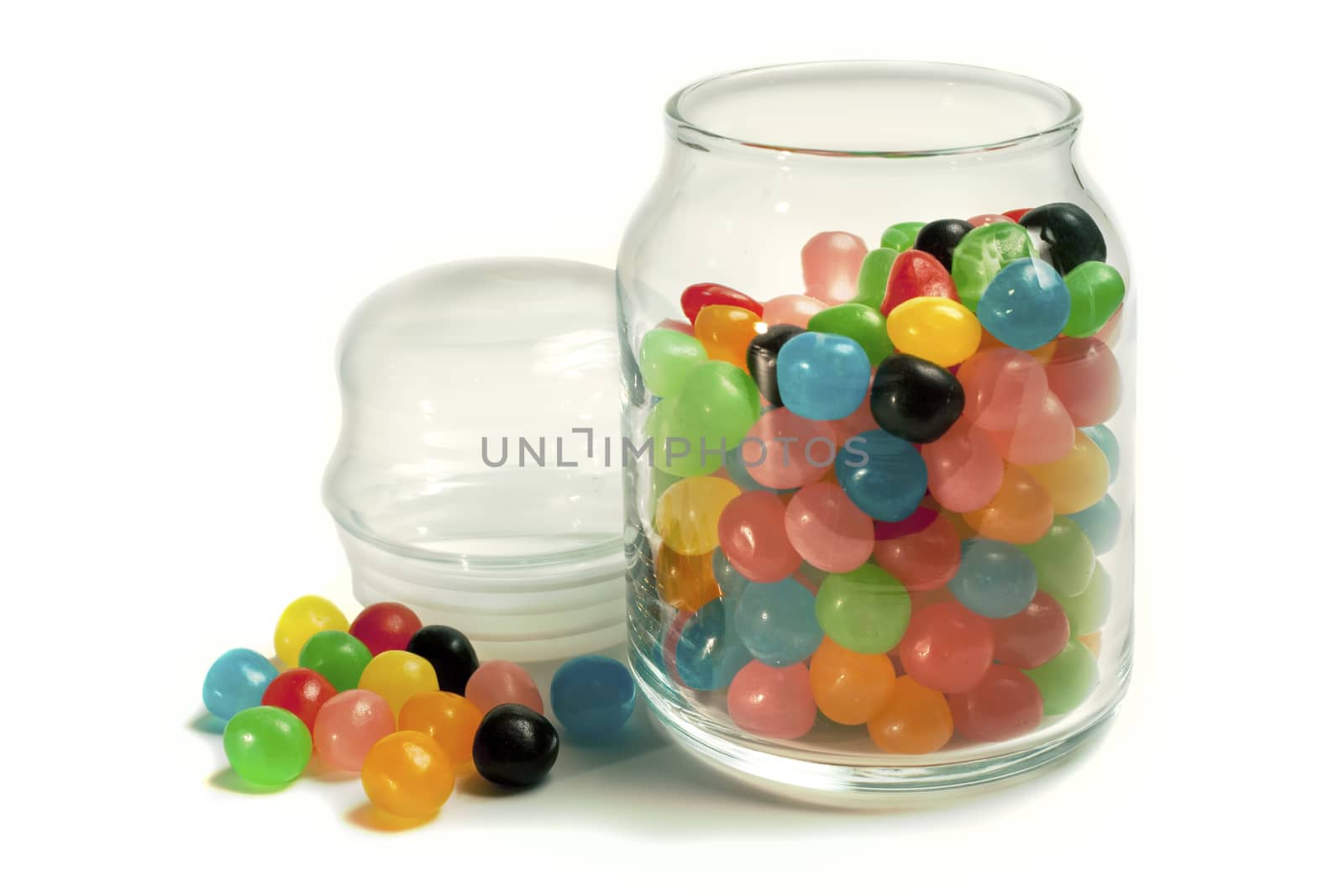 Open jar of multi colored Jelly Beans. Isolated on White.