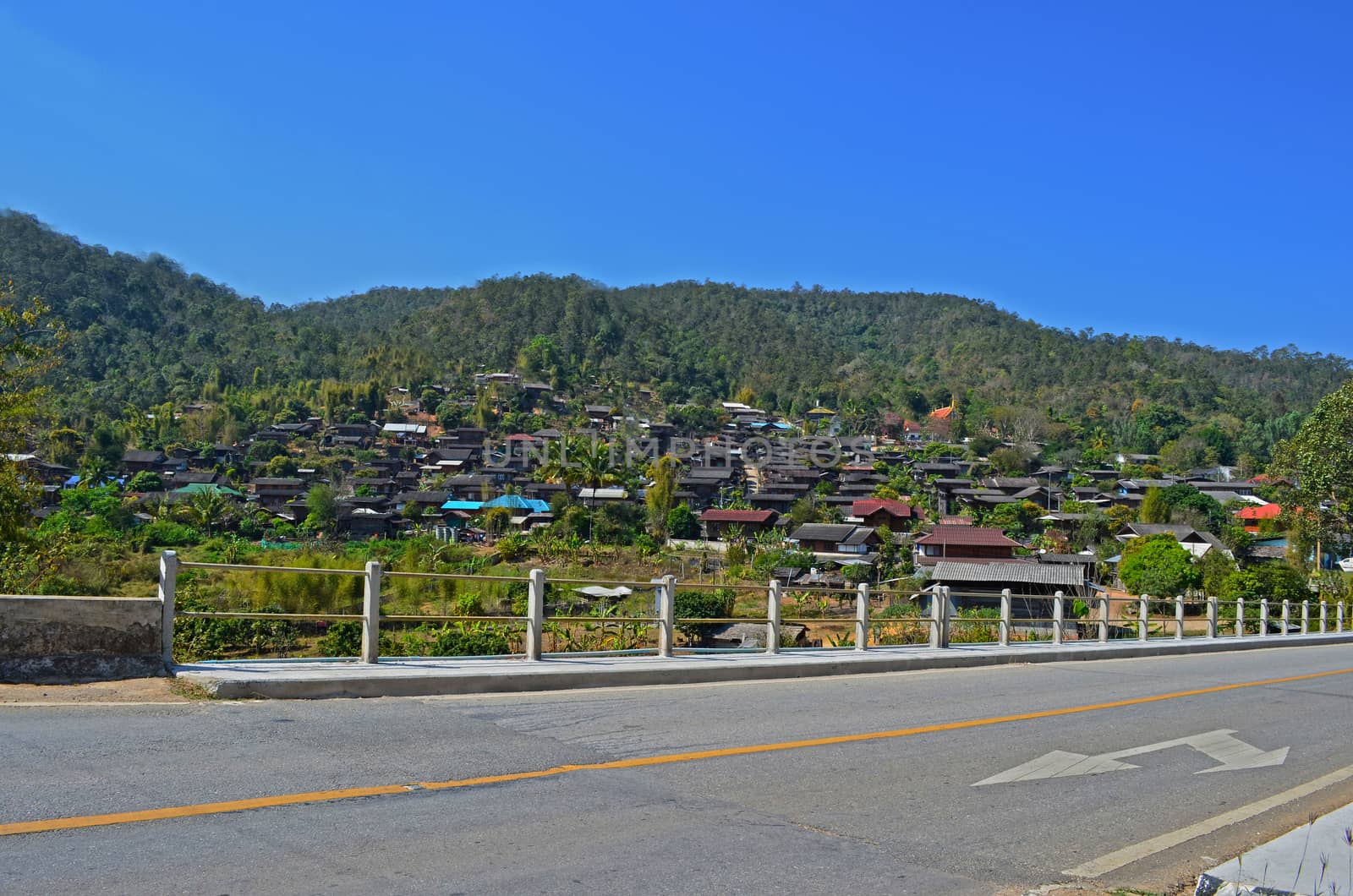 On Asphalt Road pass Country Village 1_2, Bridge, Blue Sky, Direction, Traffic Sign, Maehongson province, Thailand