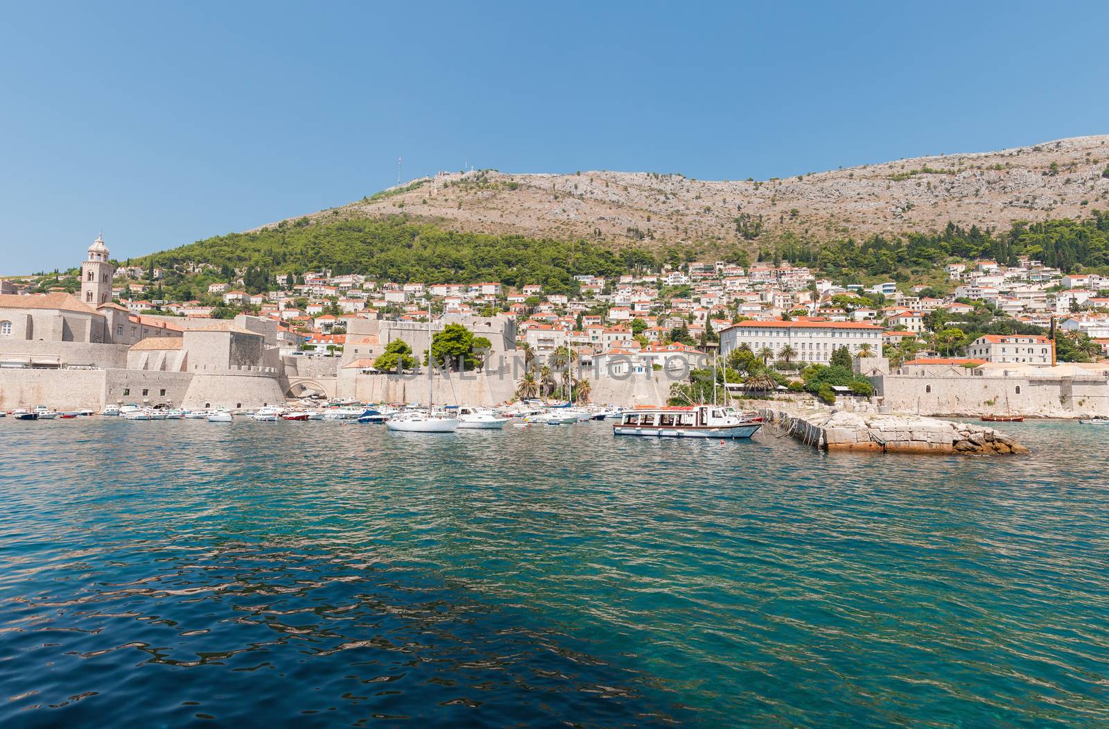 Boats moored in old town pier of Dubrovnik