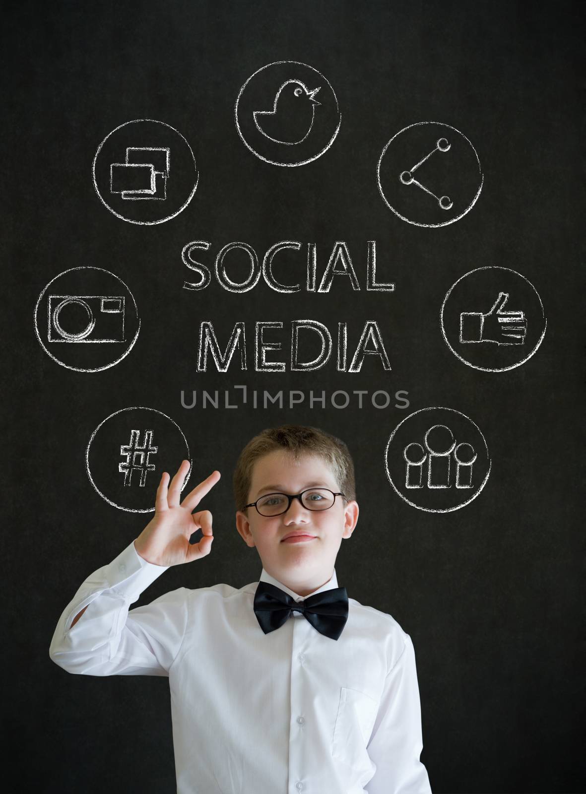 All ok or okay sign boy dressed up as business man with social media icons on blackboard background