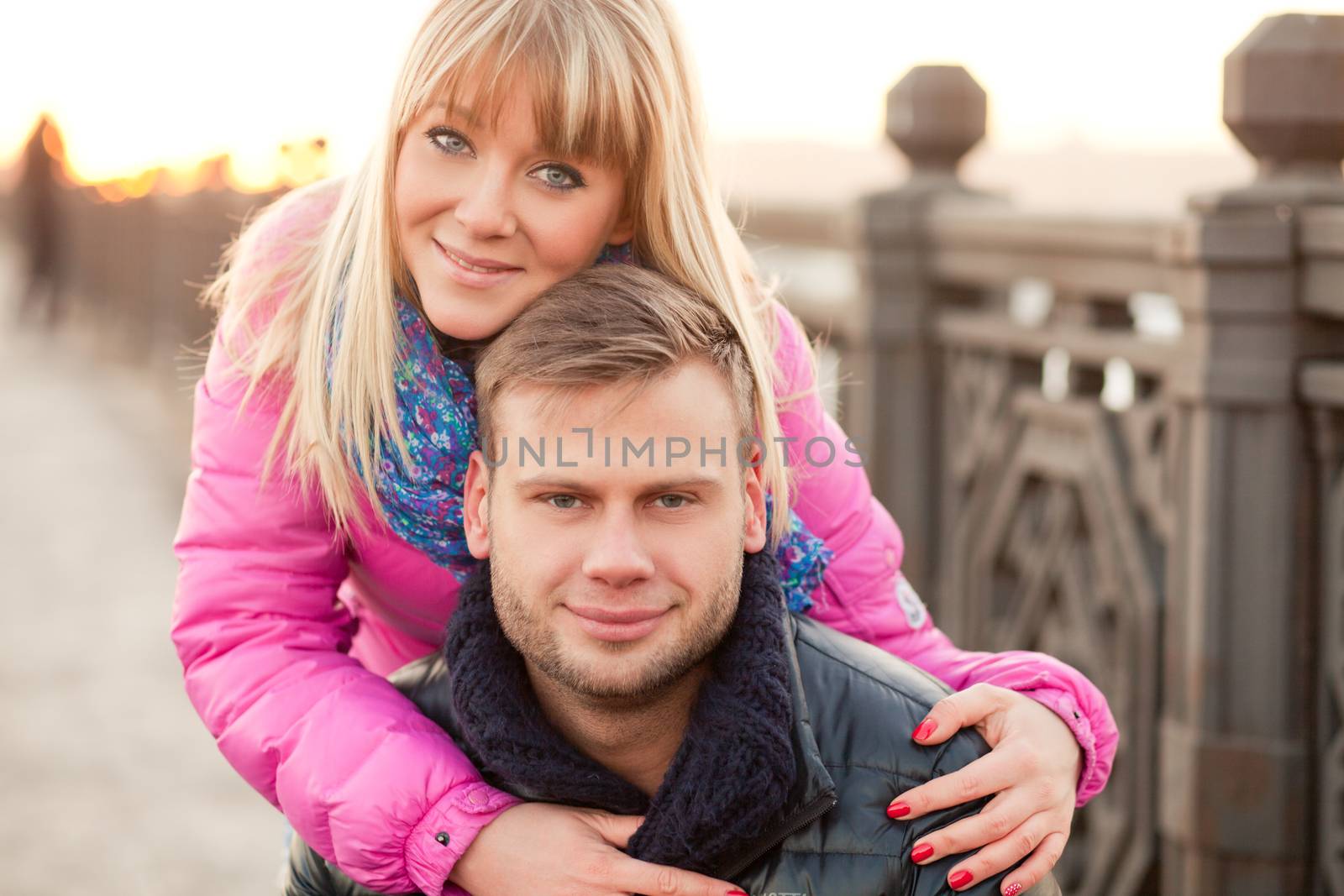 Woman is hugging her boyfriend in winter by Kor