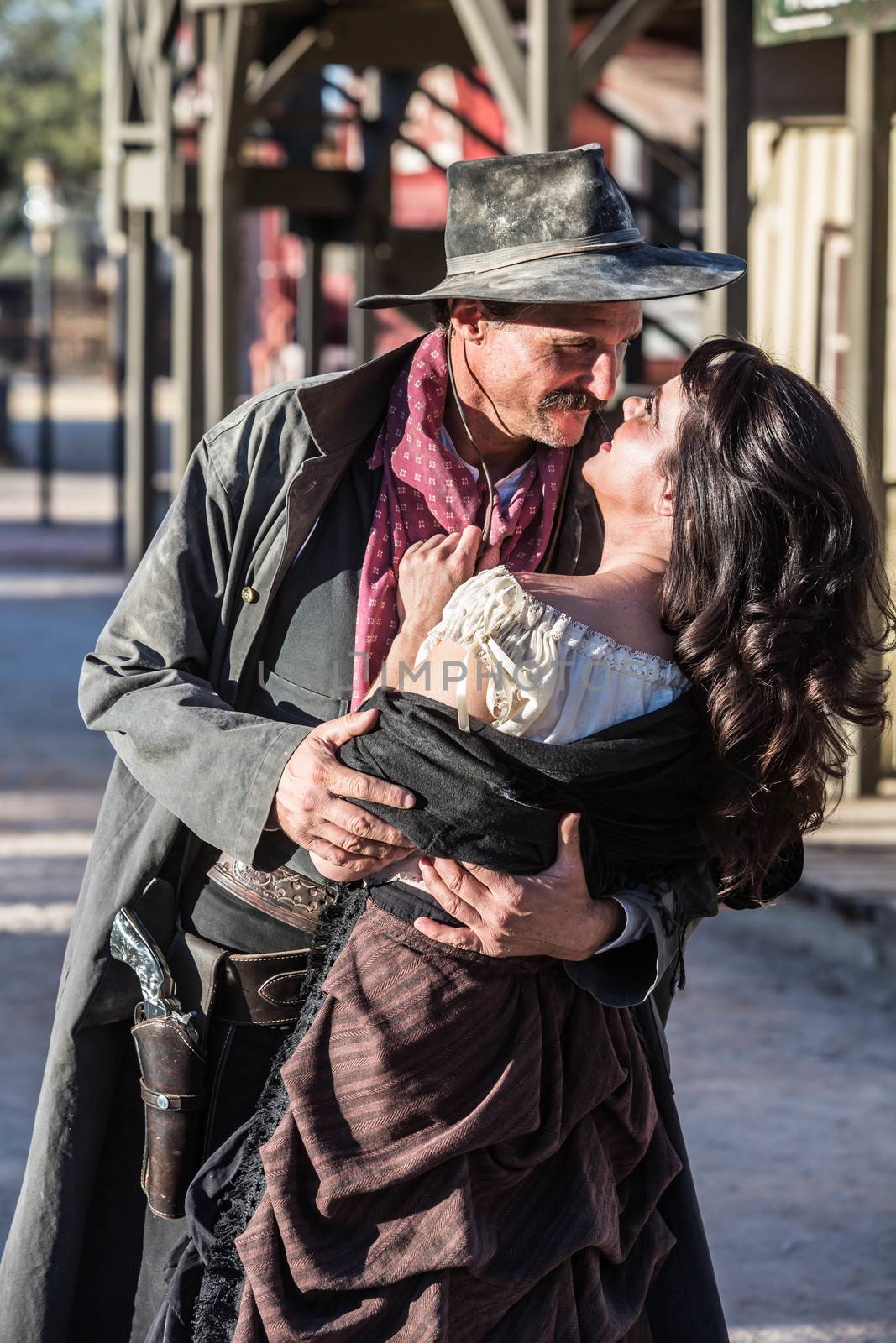 Portrait of an old west woman and sheriff kissing