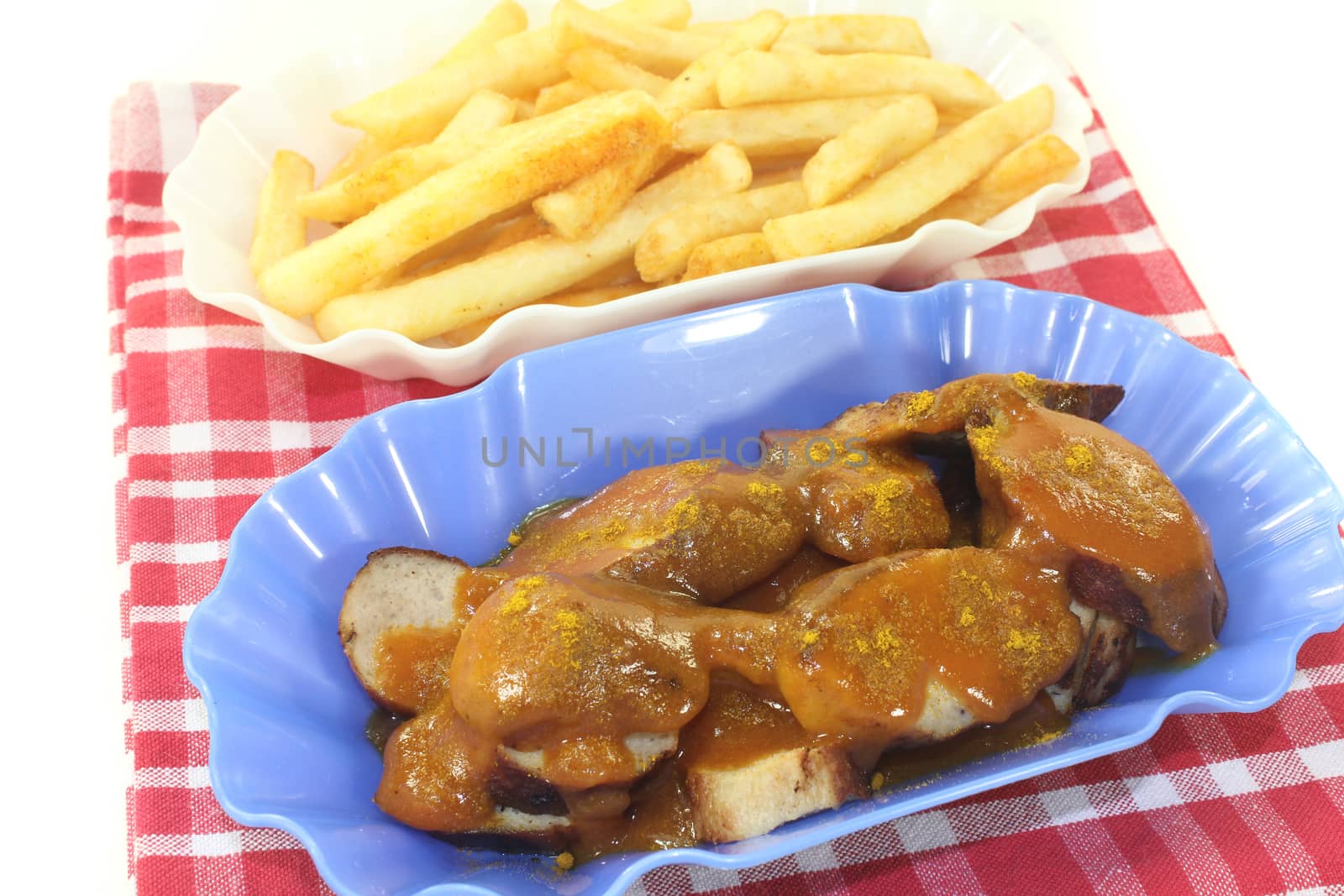 Currywurst with french fries on a light background