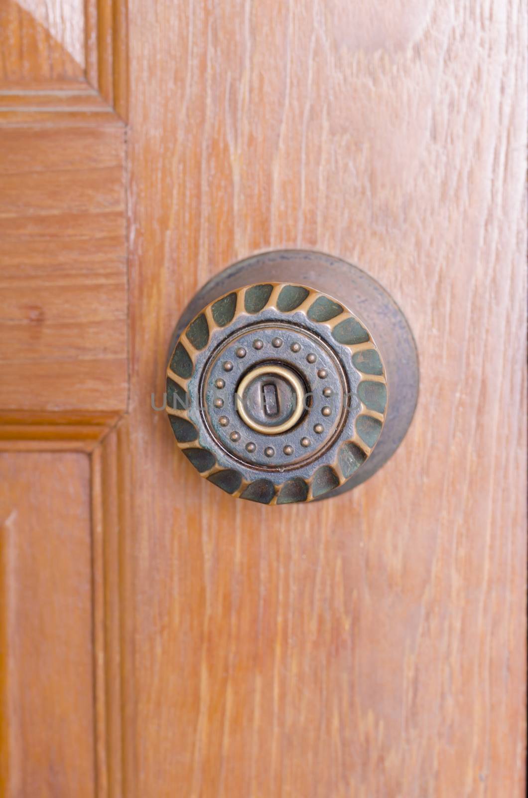 door knob and key hold on wood