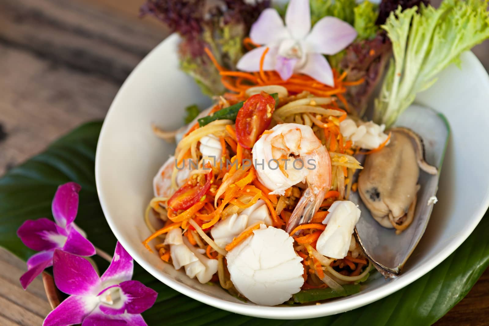 Traditional dish of freshly prepared Thai food.  Thai seafood and som tum green papaya salad.