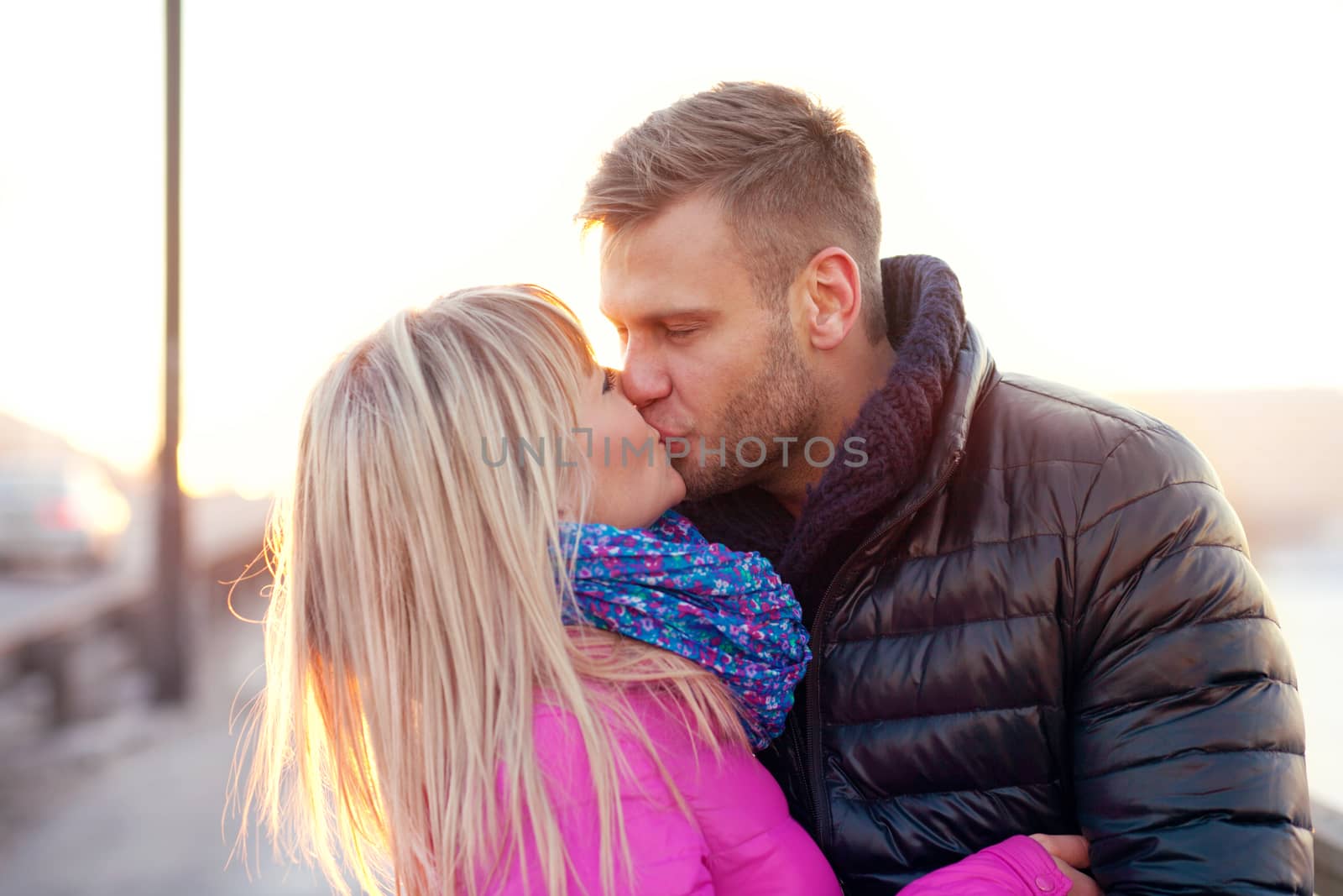 Couple kissing in winter warm clothes by Kor