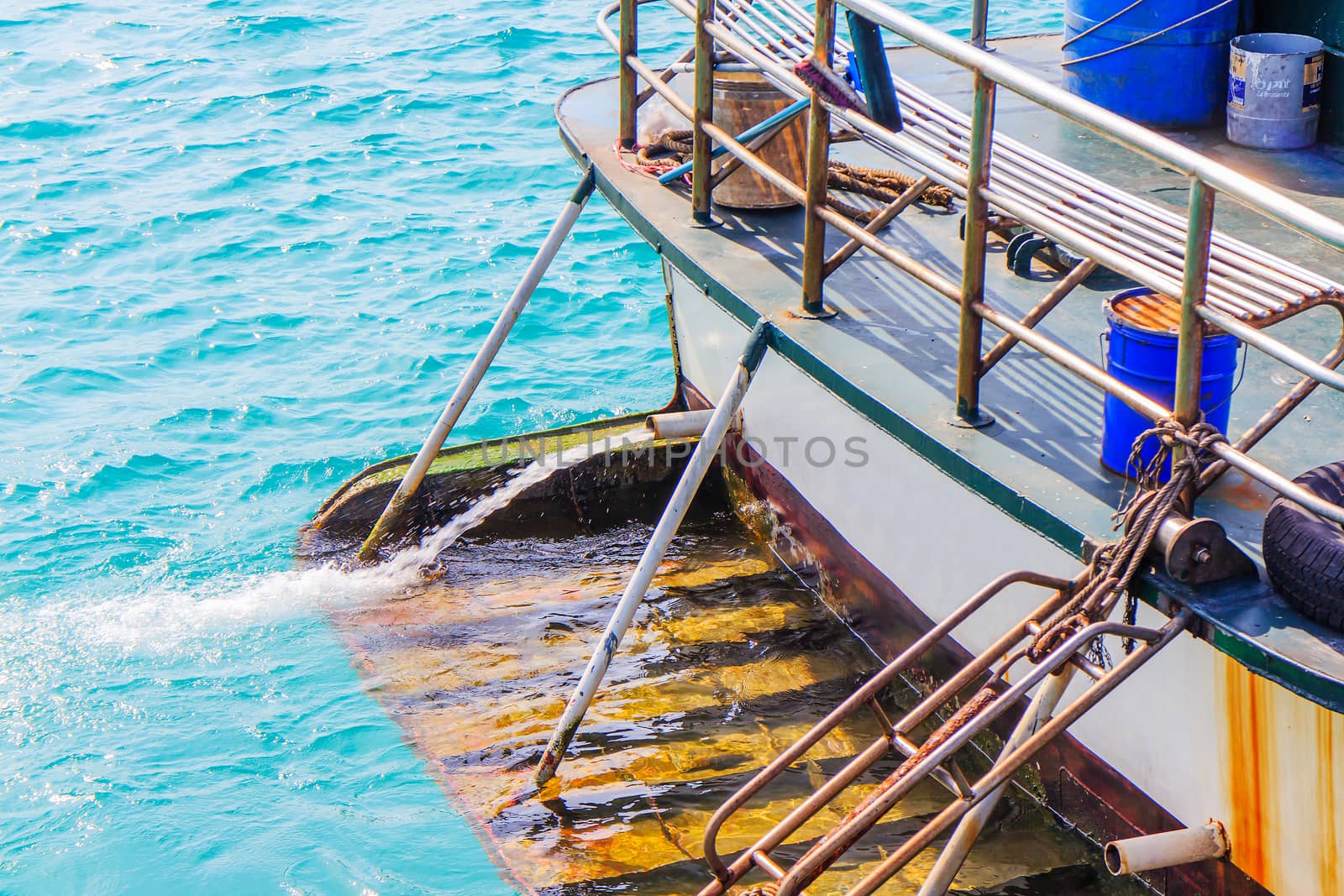 The end of a boat moored in the harbor.