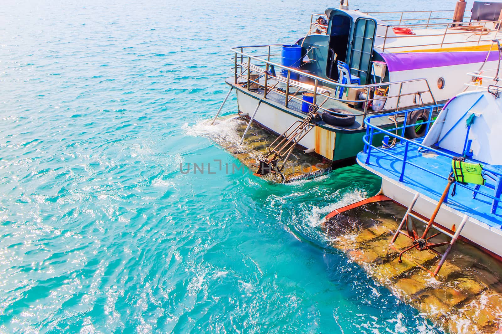 The end of a boat moored in the harbor.