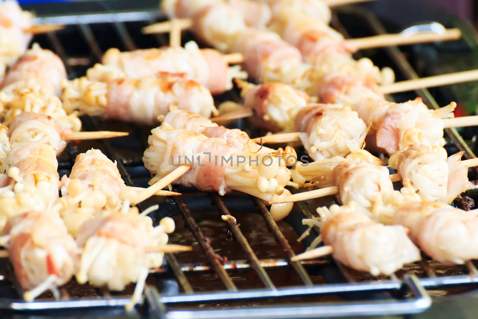 Enoki Mushrooms, wrapped with pork bacon, grilled on the stove.