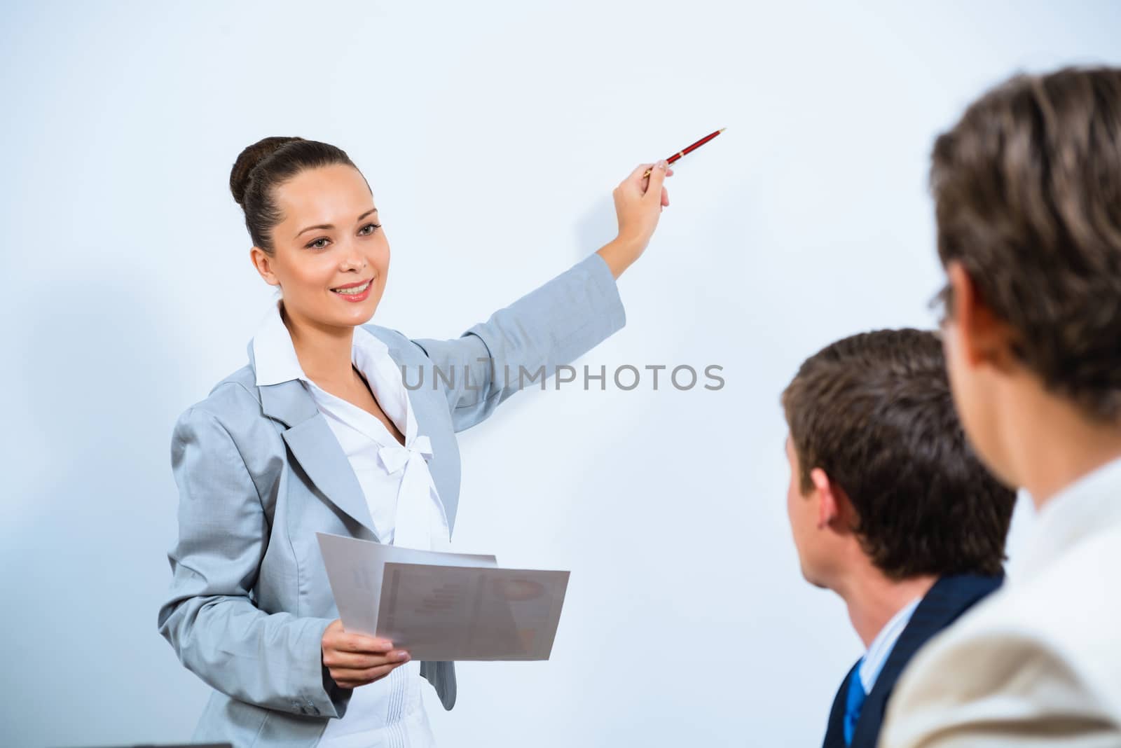 image of a business woman making a report to her colleagues