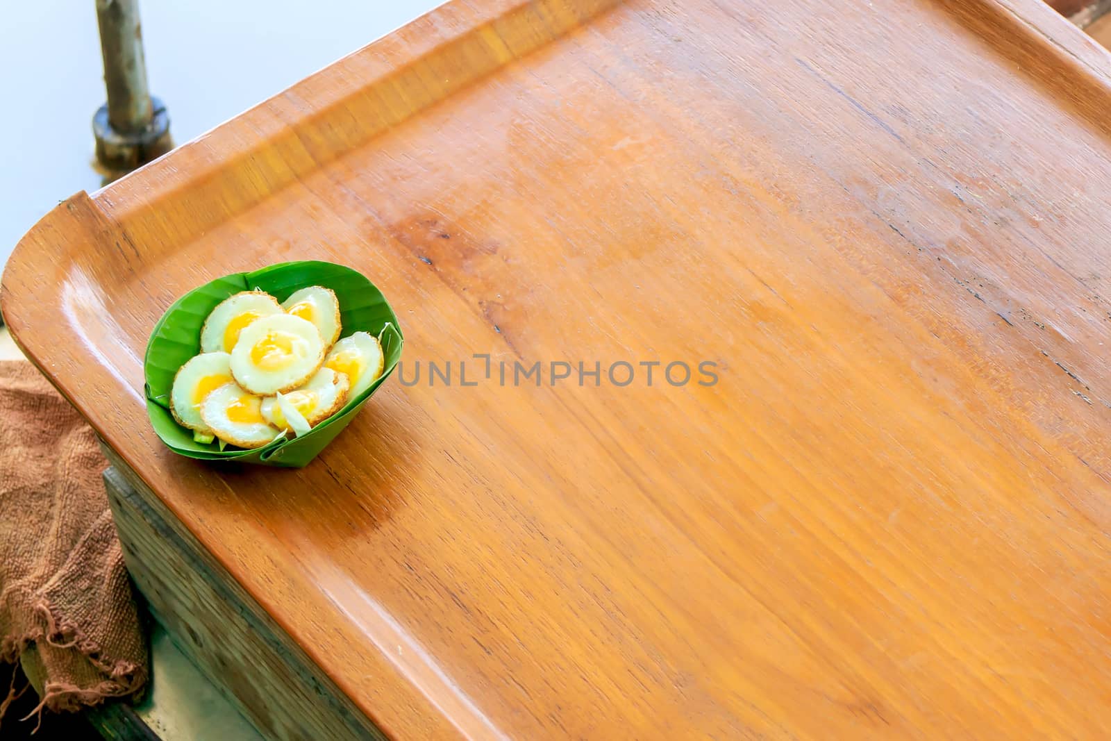 Fried Quail's egg in banana leaf cups, at outdoor market of Thailand.