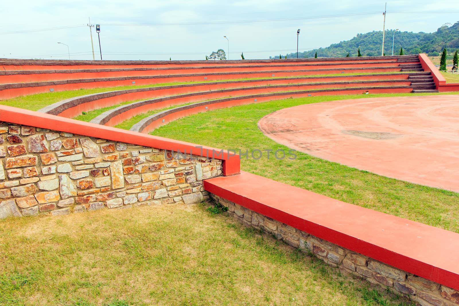 Red grandstand in arena with blue sky