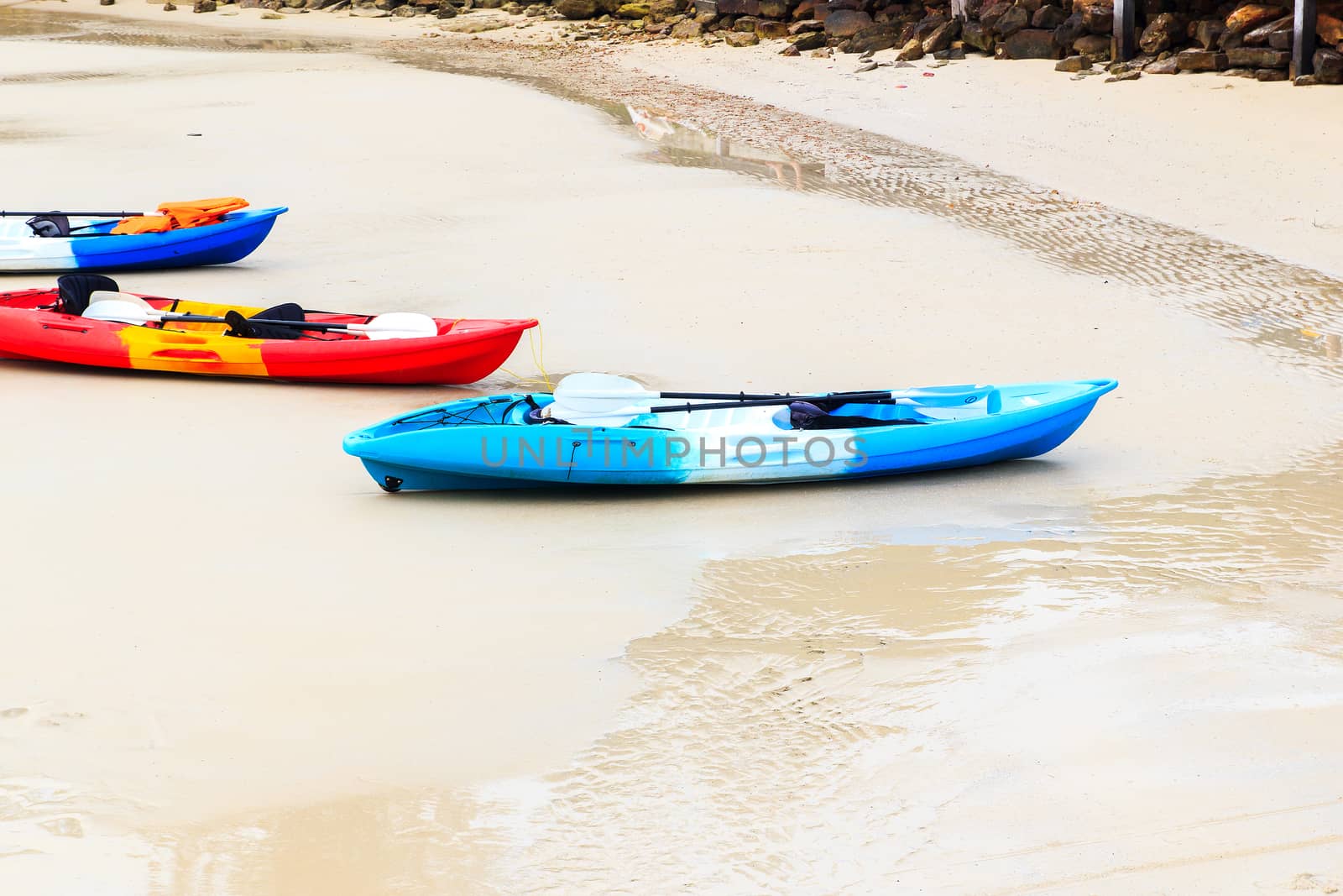 Colourful kayaks on tropical beach at KohKood, thailand.