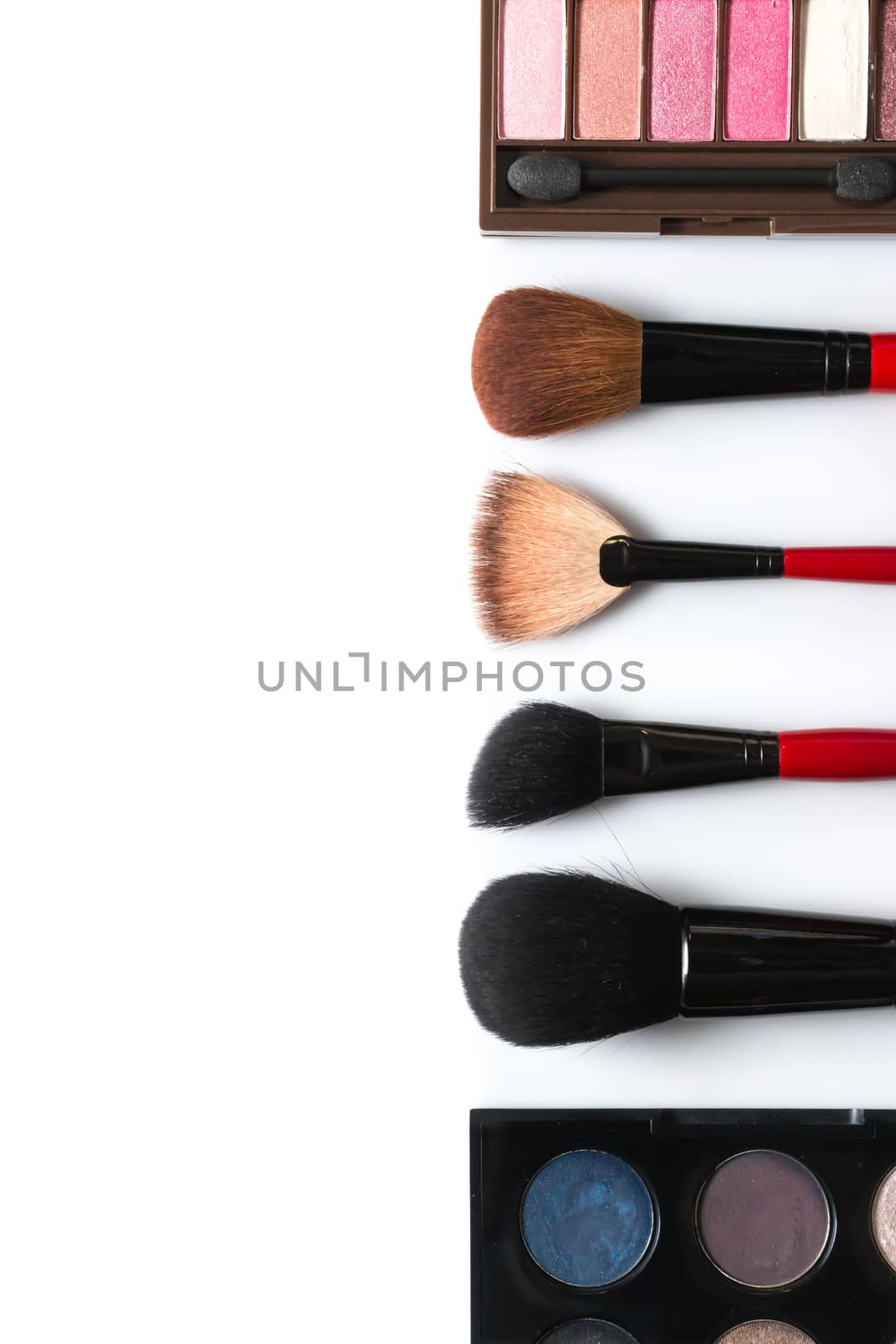 makeup brush and cosmetics, on a white background isolated