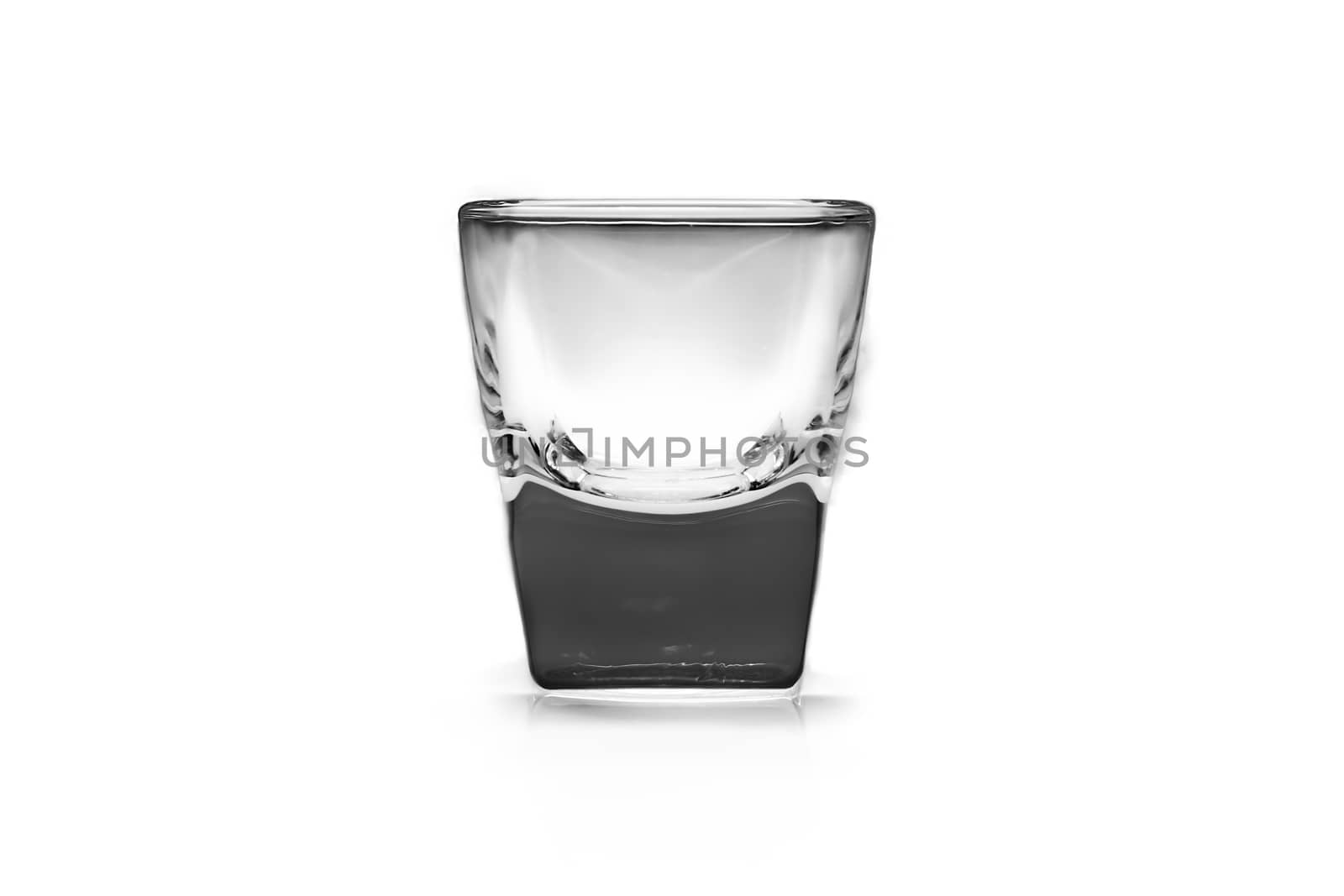 Empty shot glass on white background