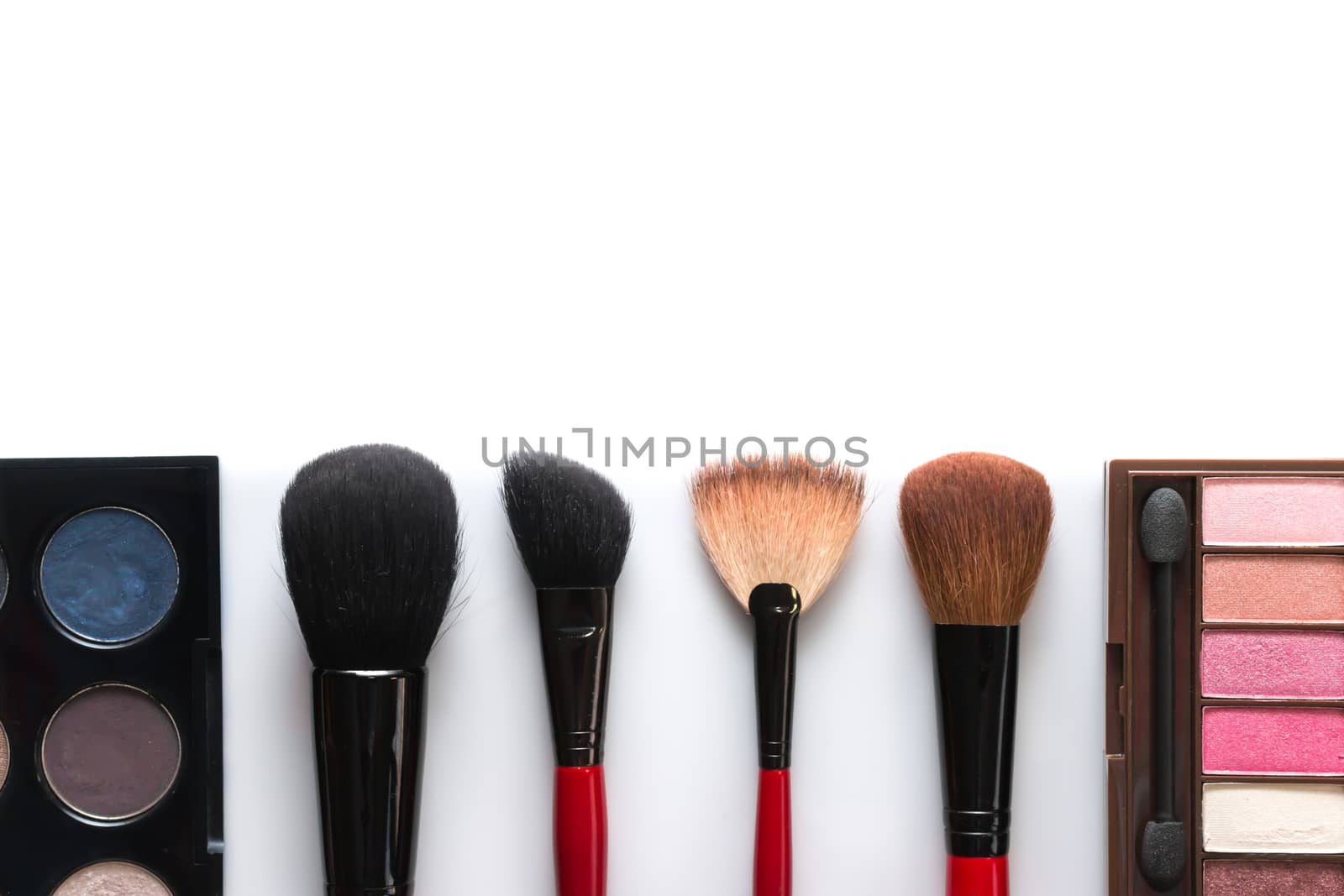 makeup brush and cosmetics, on a white background isolated
