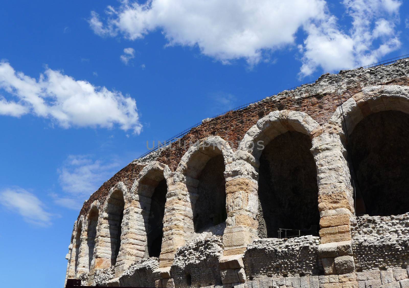 Side view of arches and details of famous ancient roman amphitheatre Arena di Verona in a sunny day with blue sky, Italy, Europe.