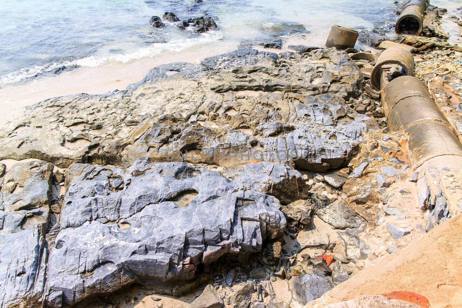 Rock reef on the beach in island.
	