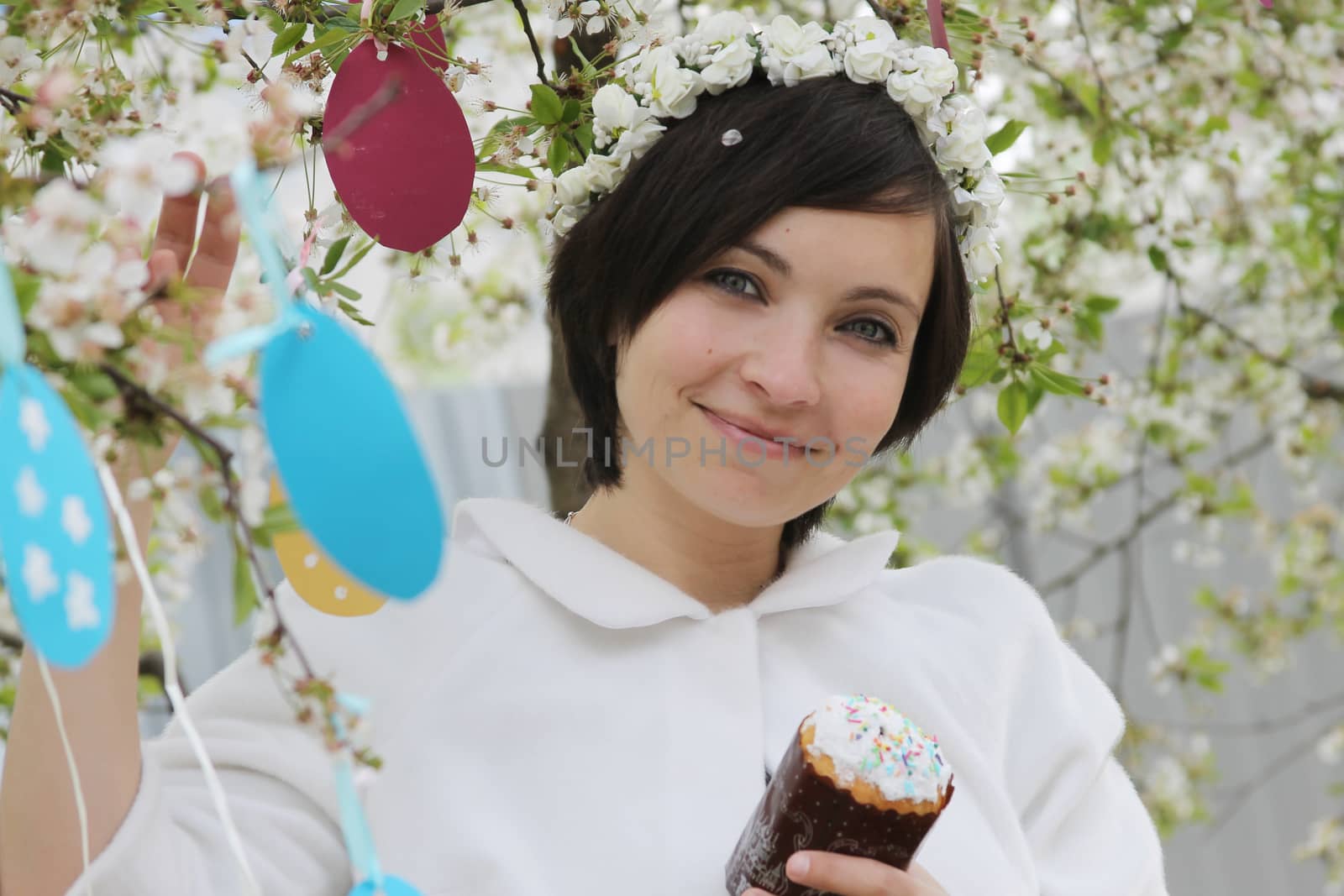 Woman with wreath and Easter cake among spring garden by Angel_a