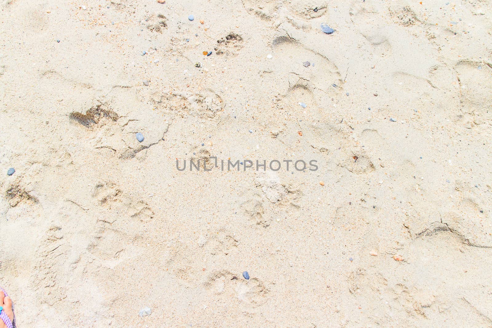 Clean white sand, and the stones are small.