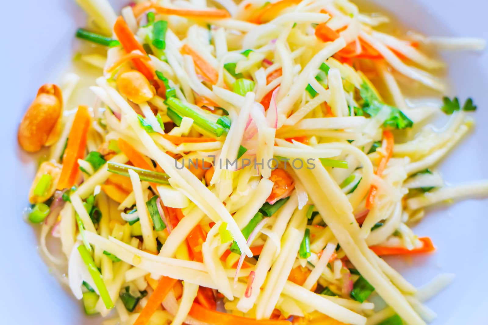 A spicy mango salad with vegetable and chili.