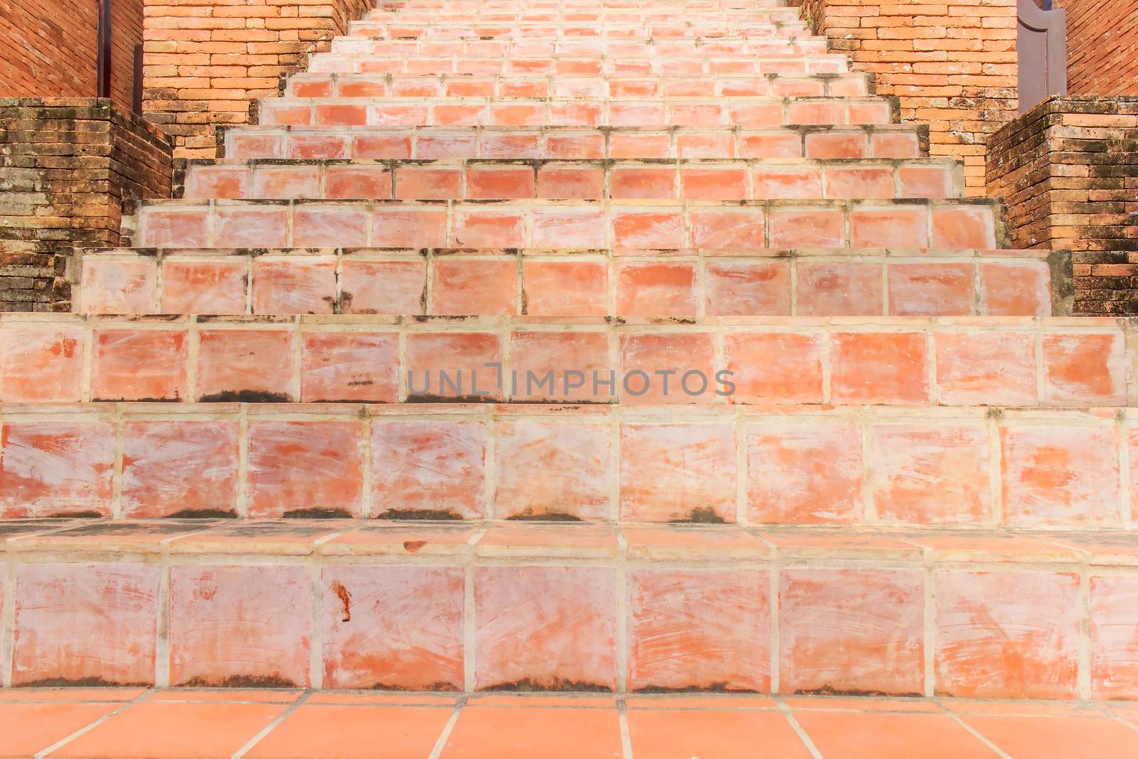 The way up stair are made from red brick.