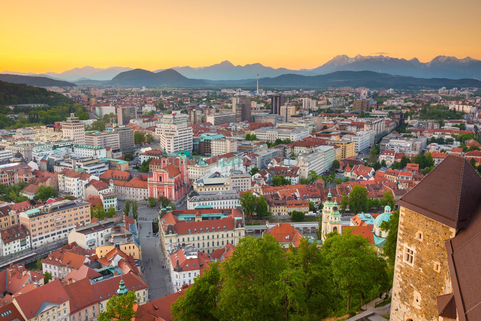 Panorama of the Slovenian capital Ljubljana at sunset. Alps mountains