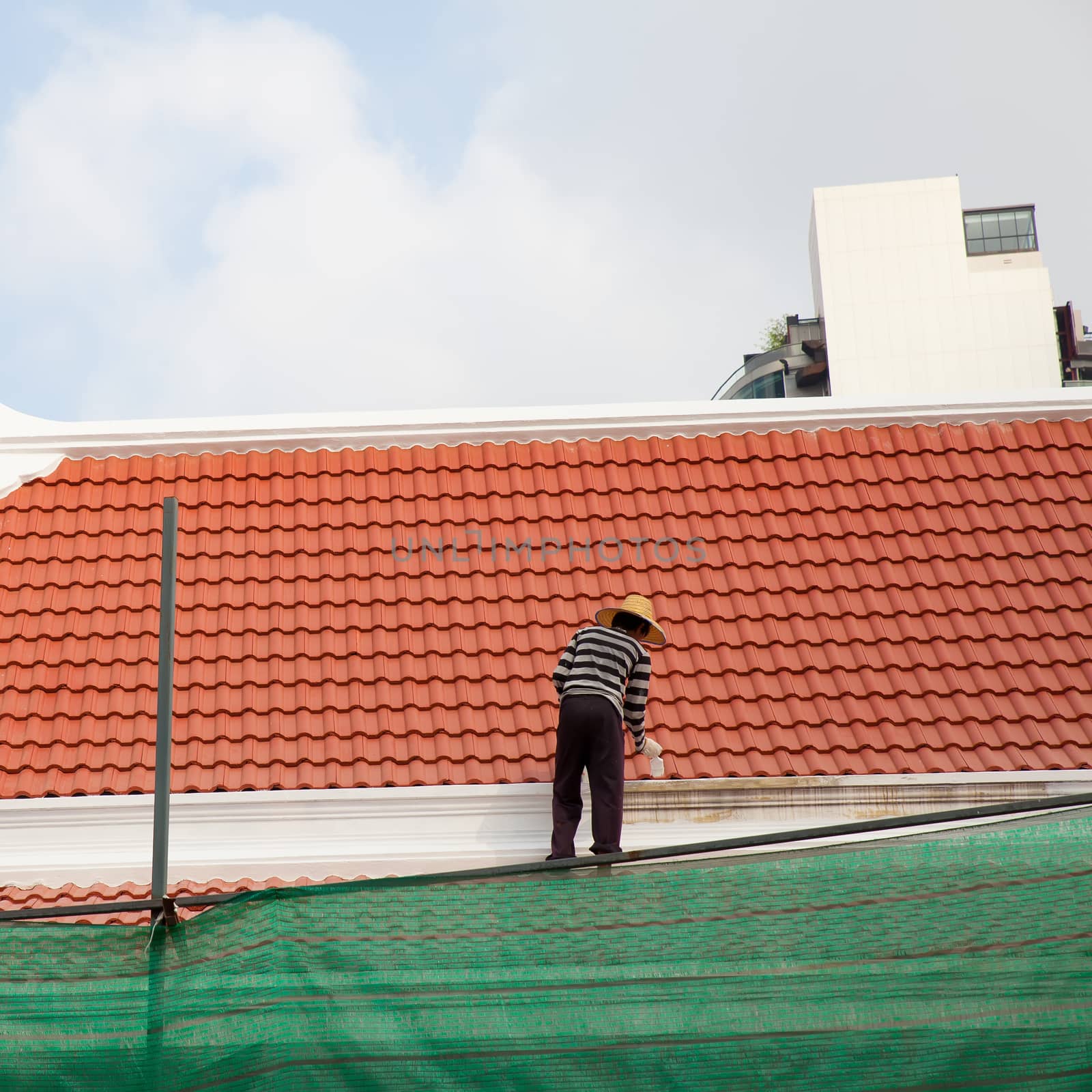 painter paintting new paint at soffit on roof