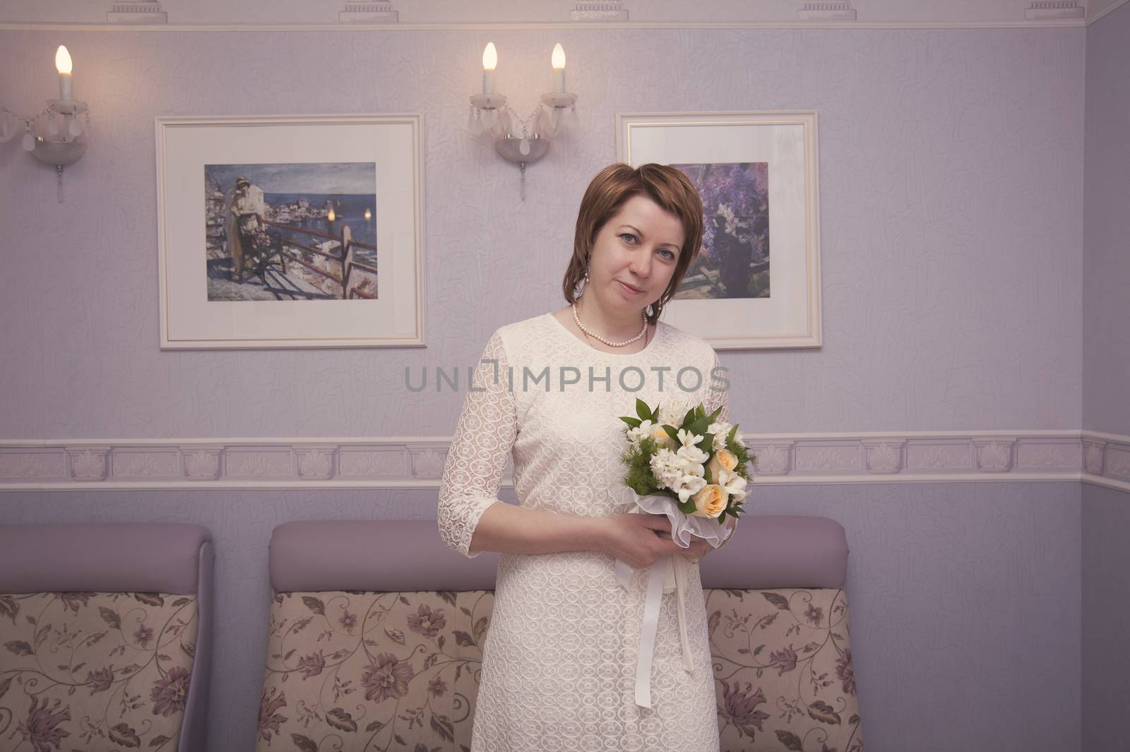 bride with a bouquet of flowers in interior