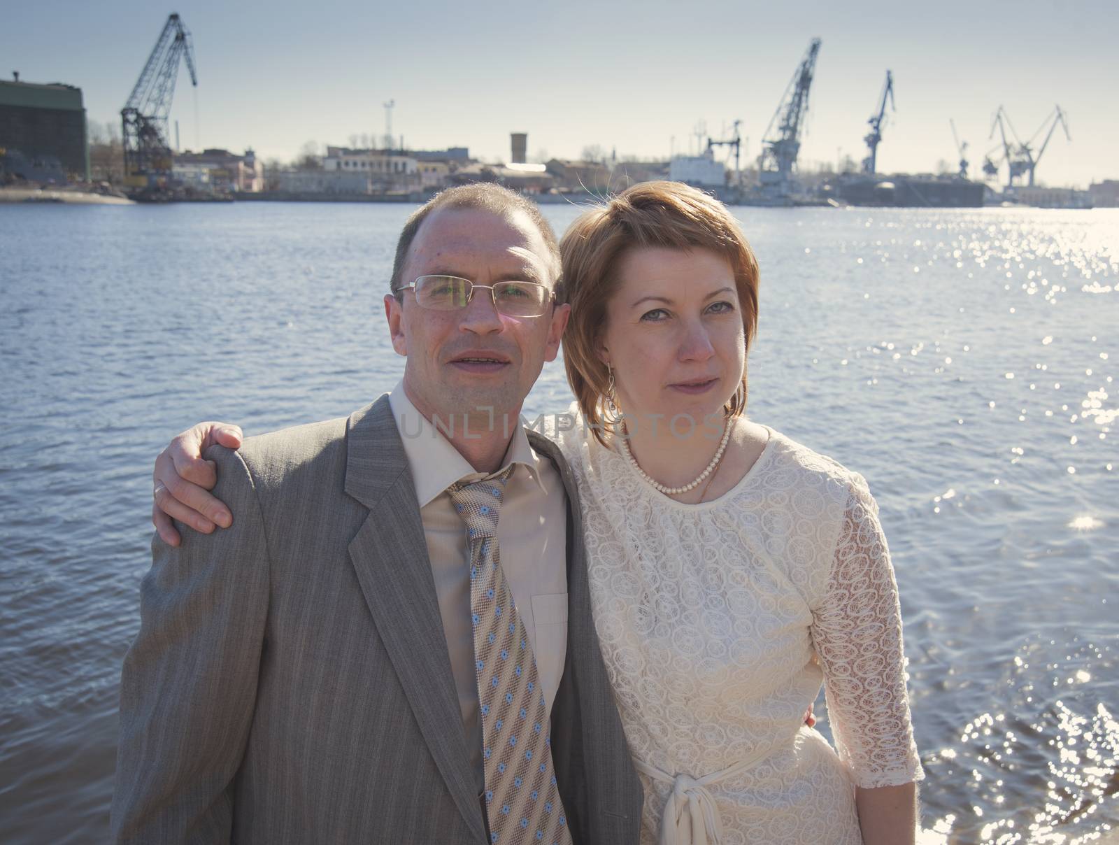 couple walk along the embankment of the river