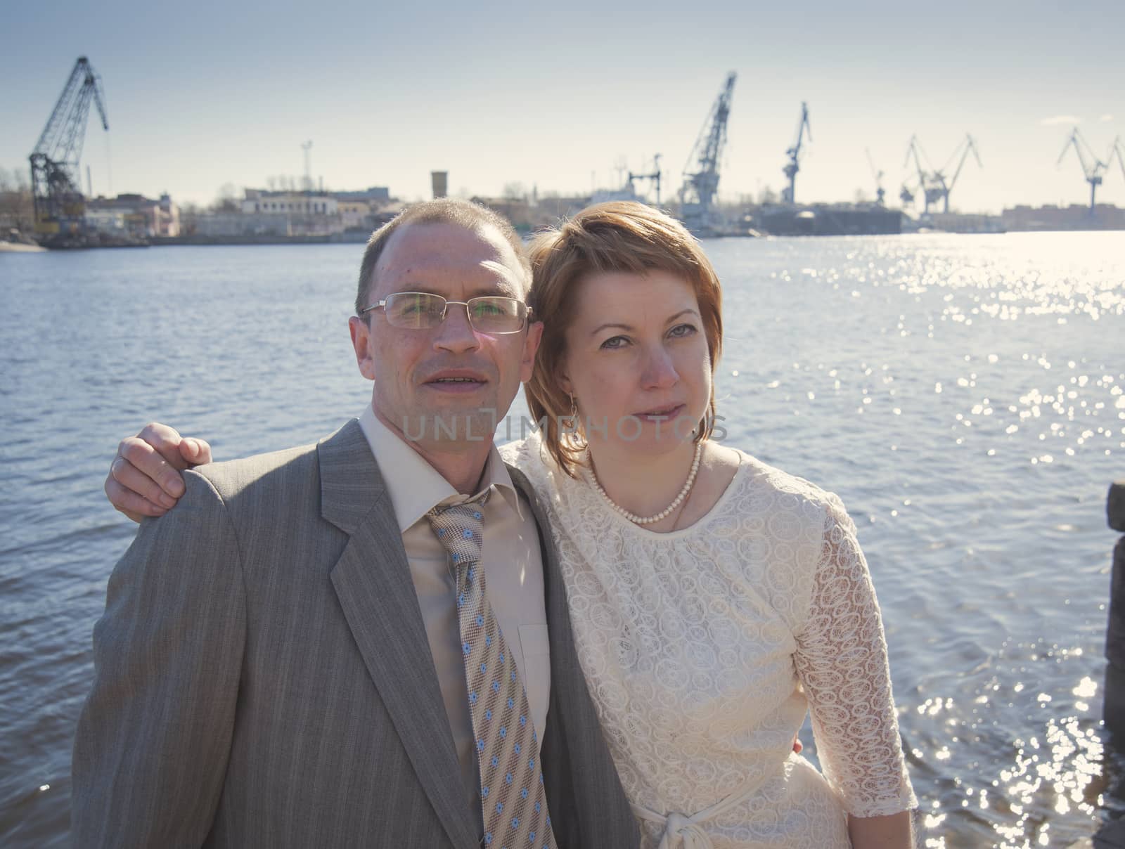 couple walk along the embankment of the river