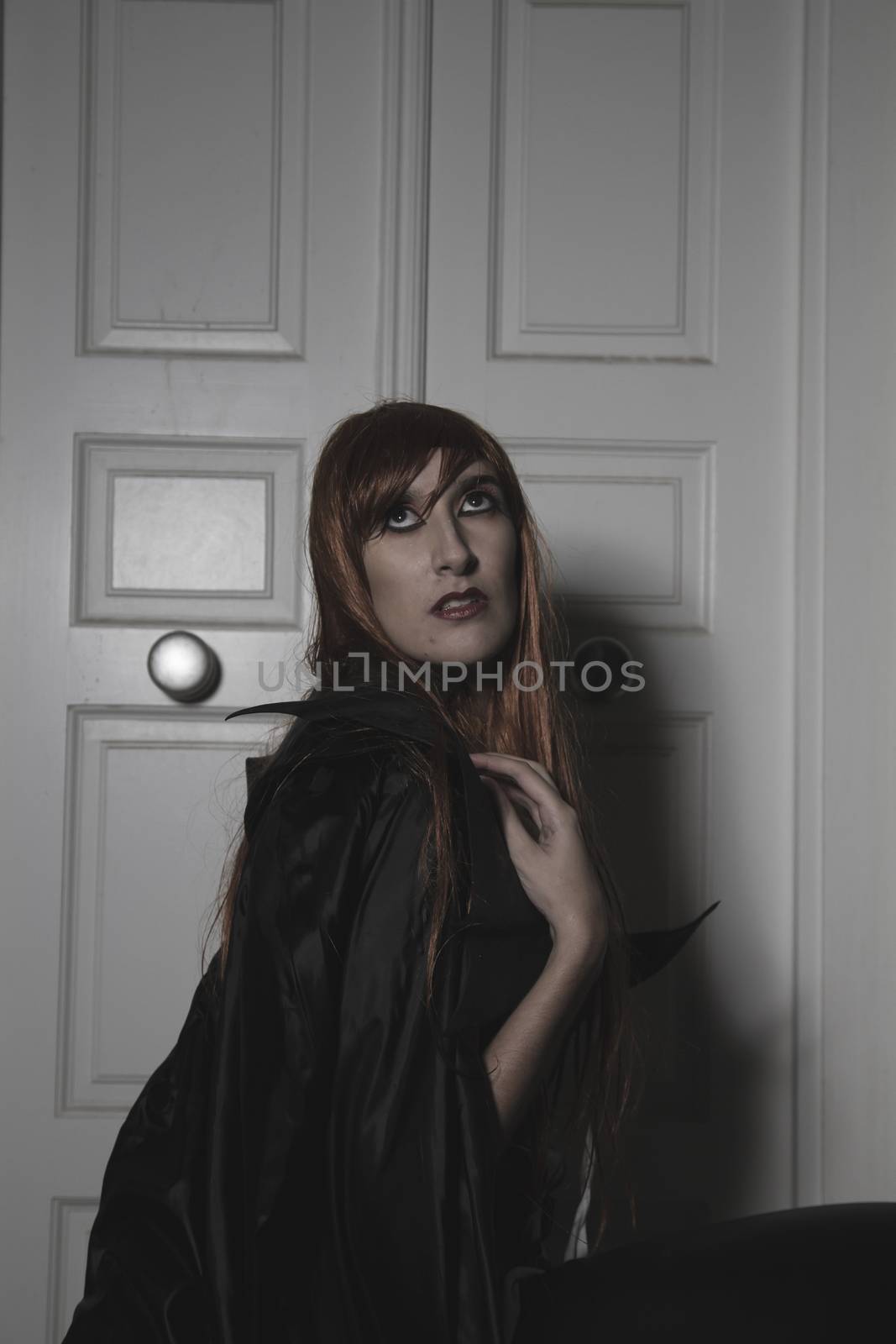 Sad, Dark beauty under rain, red hair woman with long black coat