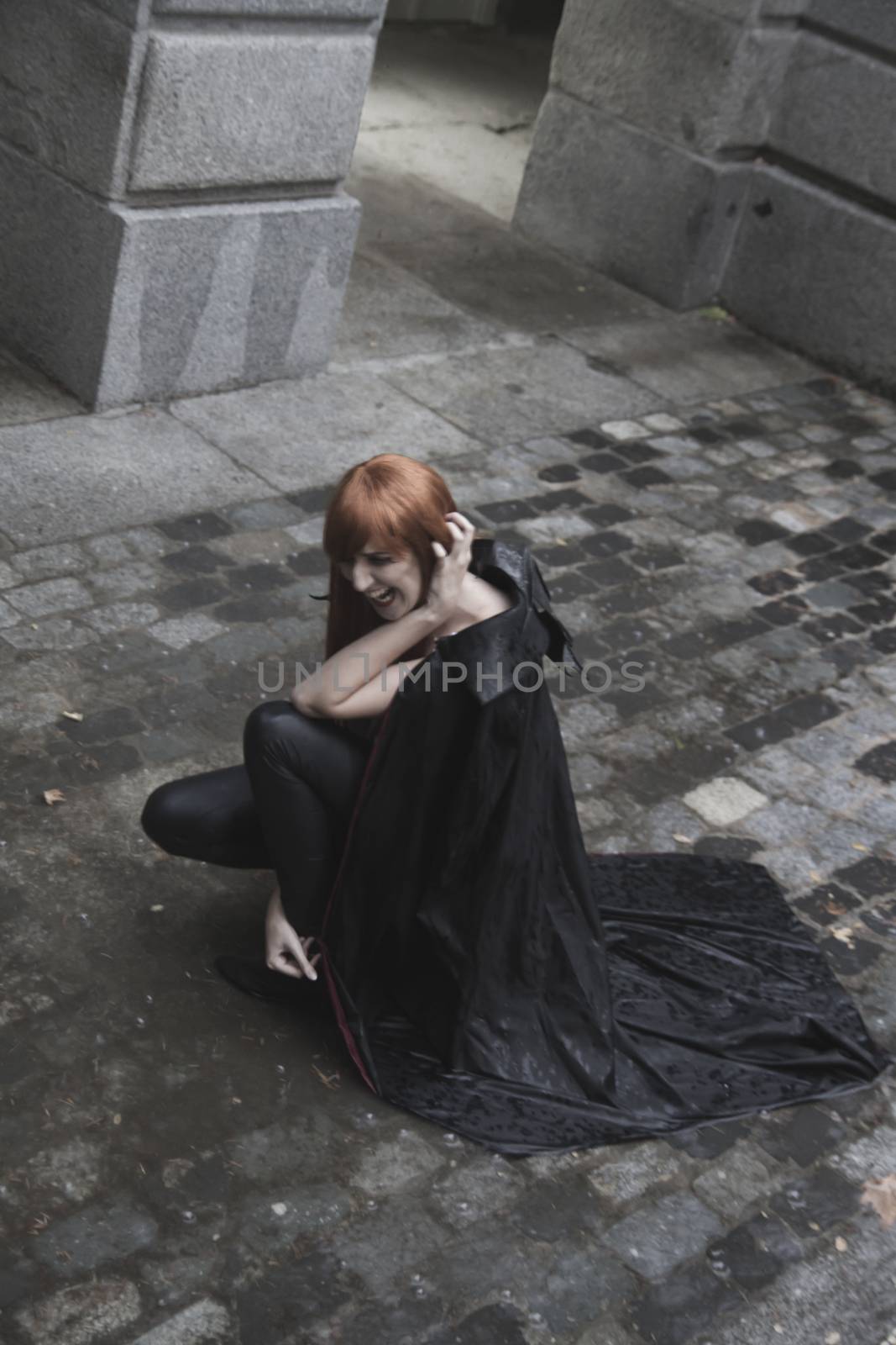 Dark beauty under rain, red hair woman with long black coat by FernandoCortes