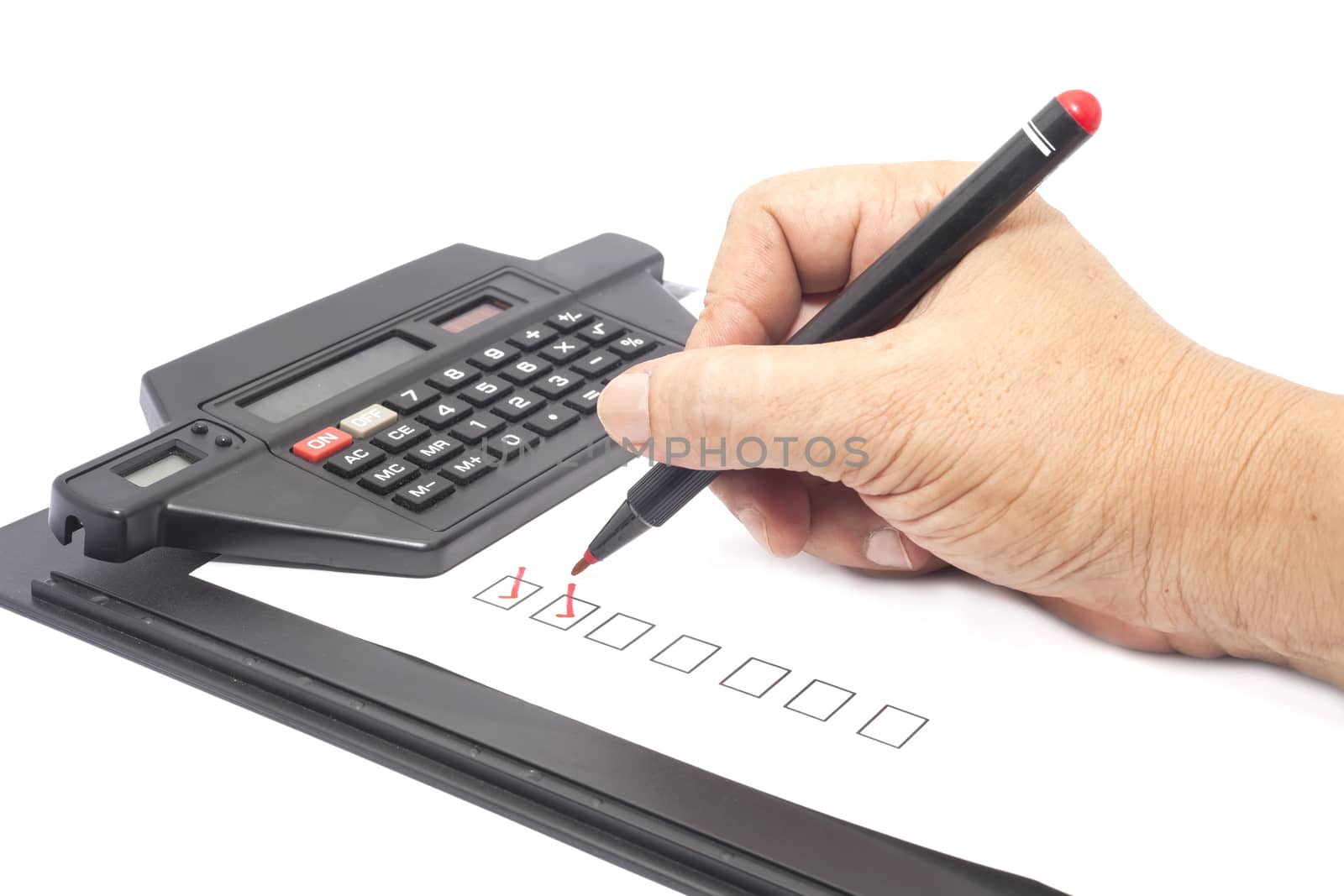 human hand drawing red check mark in checklist box
