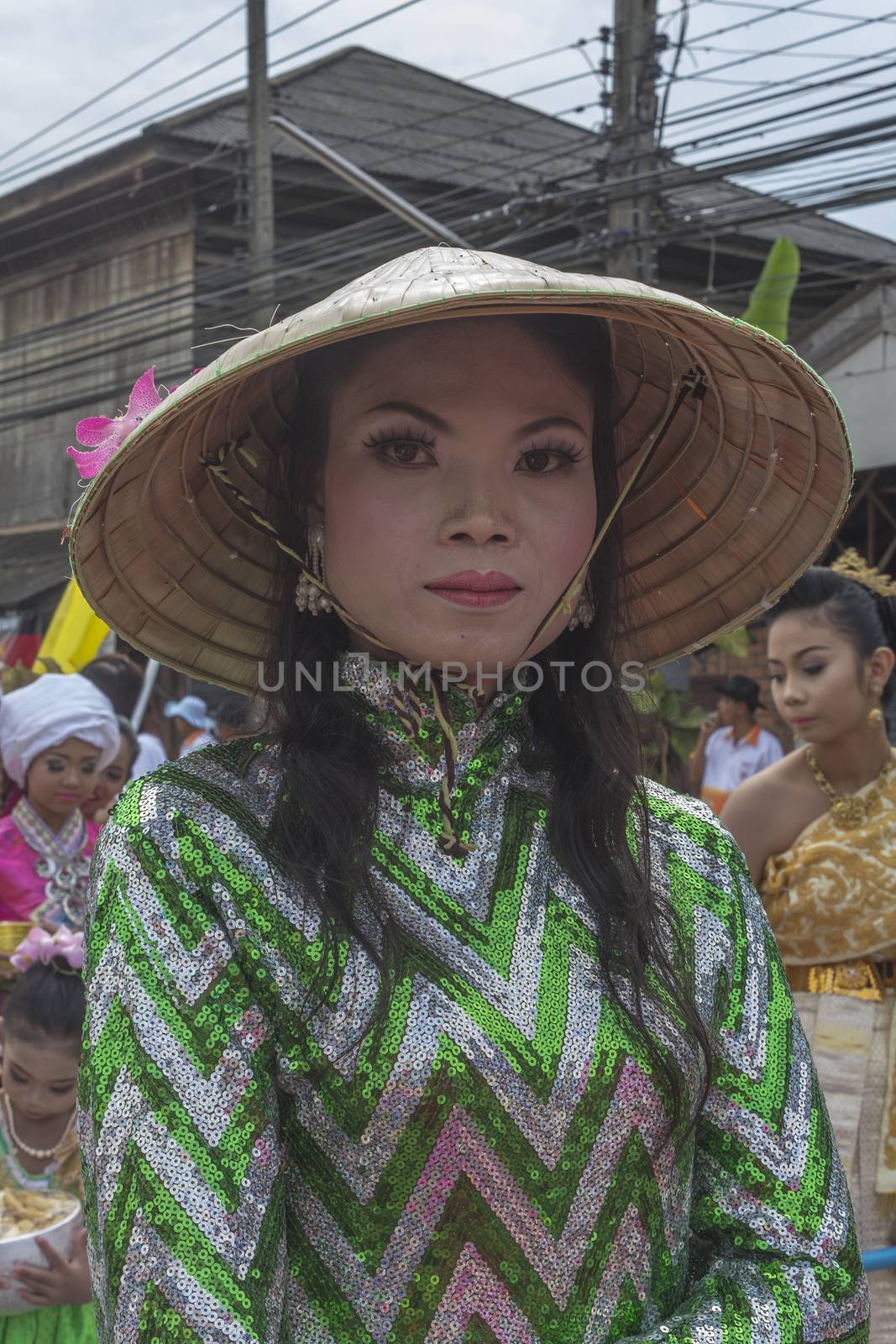 THAILAND - OCTOBER 20: Unidentified woman participates in "Ngan Chak Pra", a traditional buddhist festival on October 20, 2013 in Chaiya,Suratthani, Thailand.