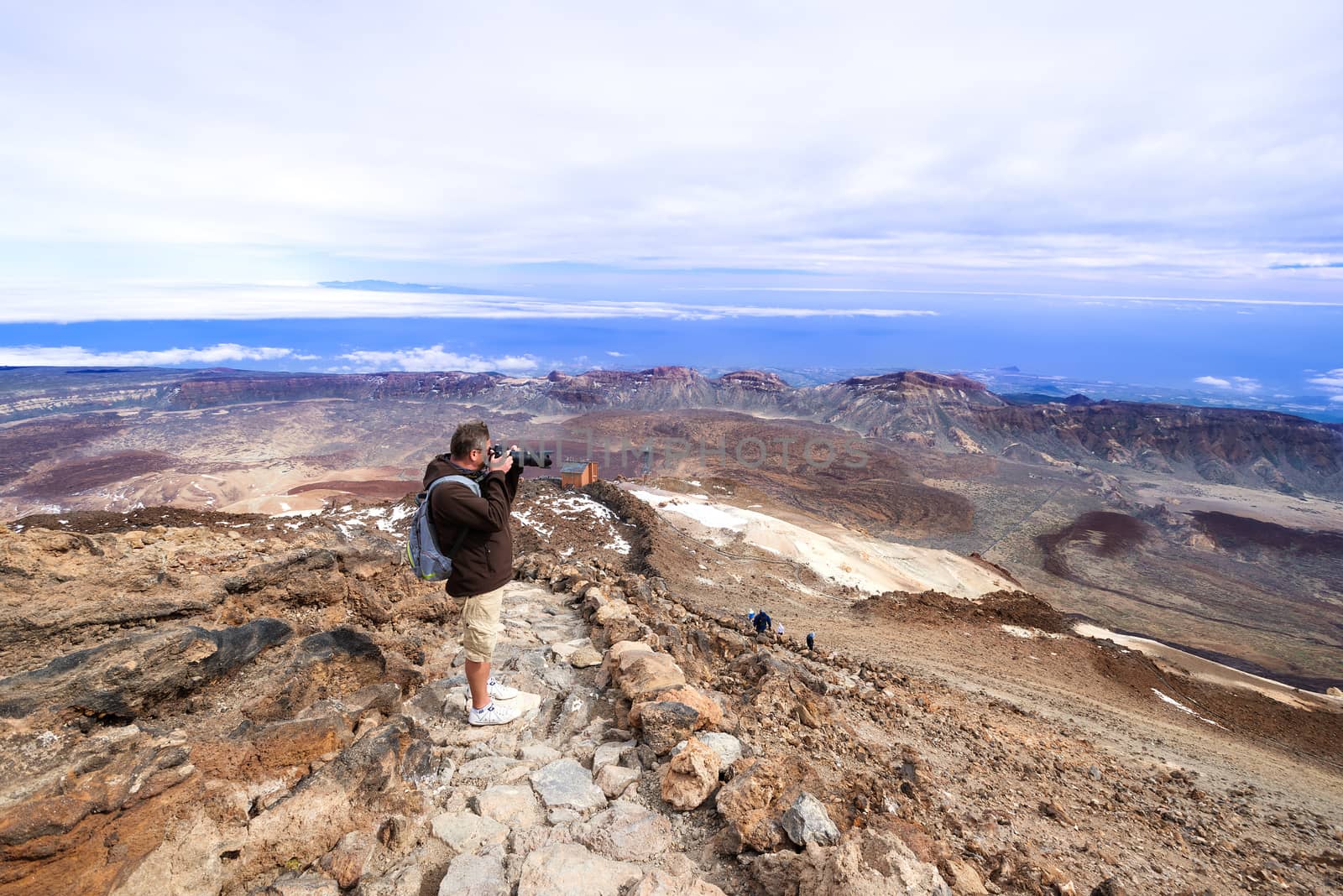 Man taking picture near volcano Teide by Nanisimova