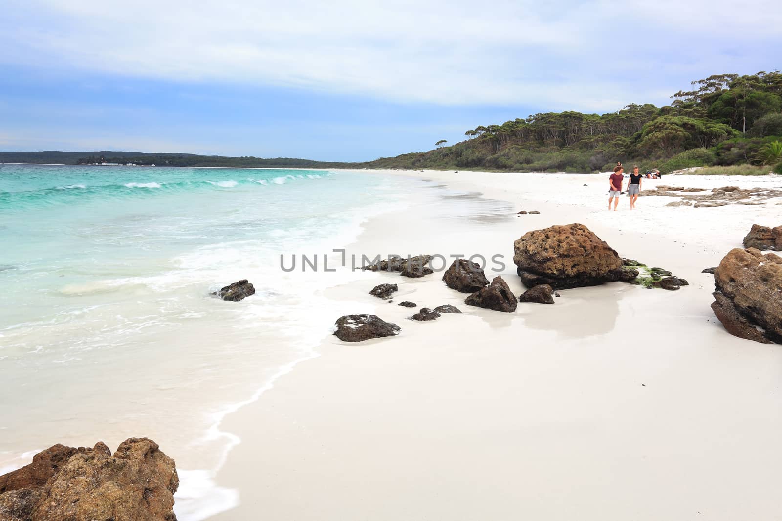 Tourists or holiday makers enjoy the white sands and aqua waters of Hyams Beach Jervis Bay Australia