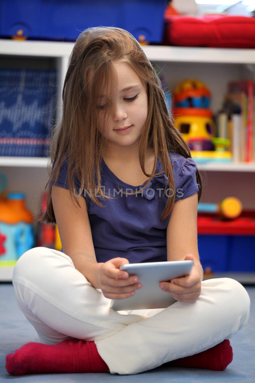 Happy pre-teen girl using a digital tablet computer