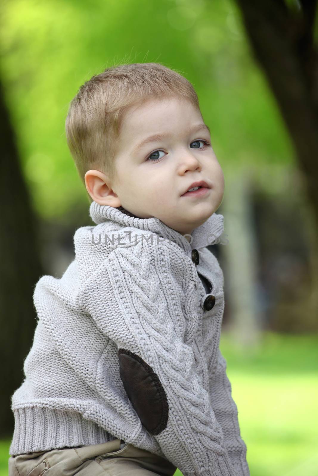 Trendy 2 years old baby boy posing in spring/autumn park