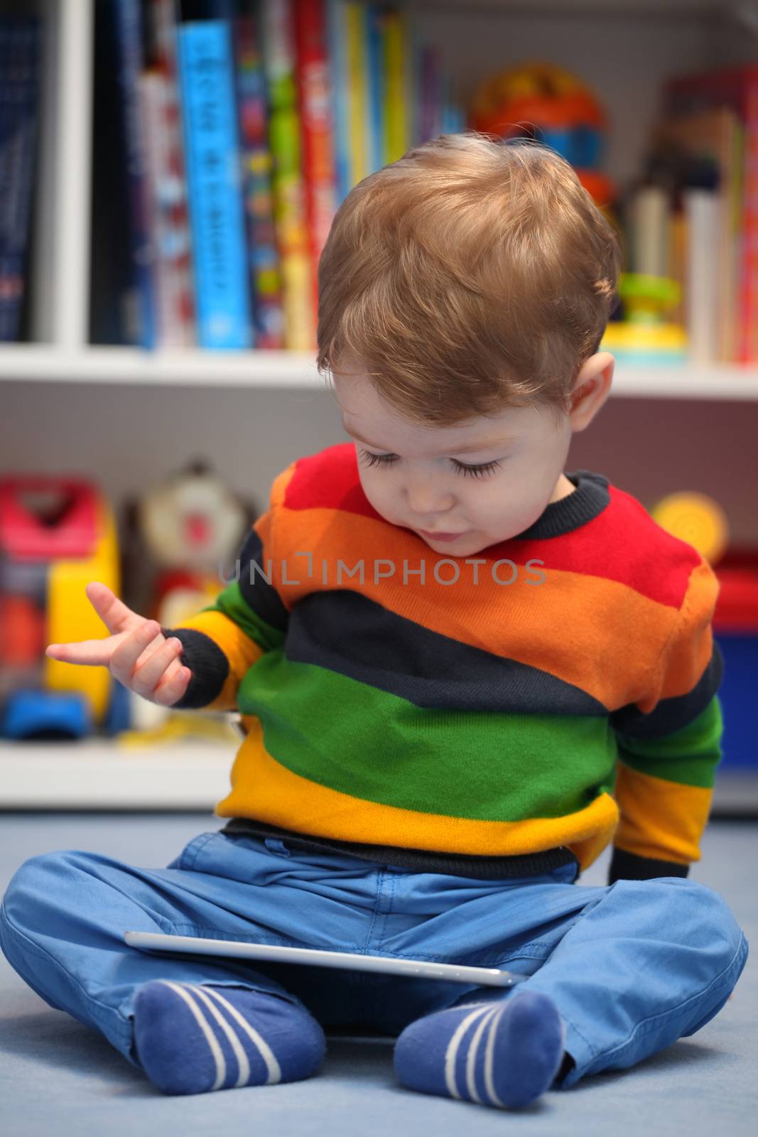 Happy 2 years old boy using a digital tablet computer by vladacanon