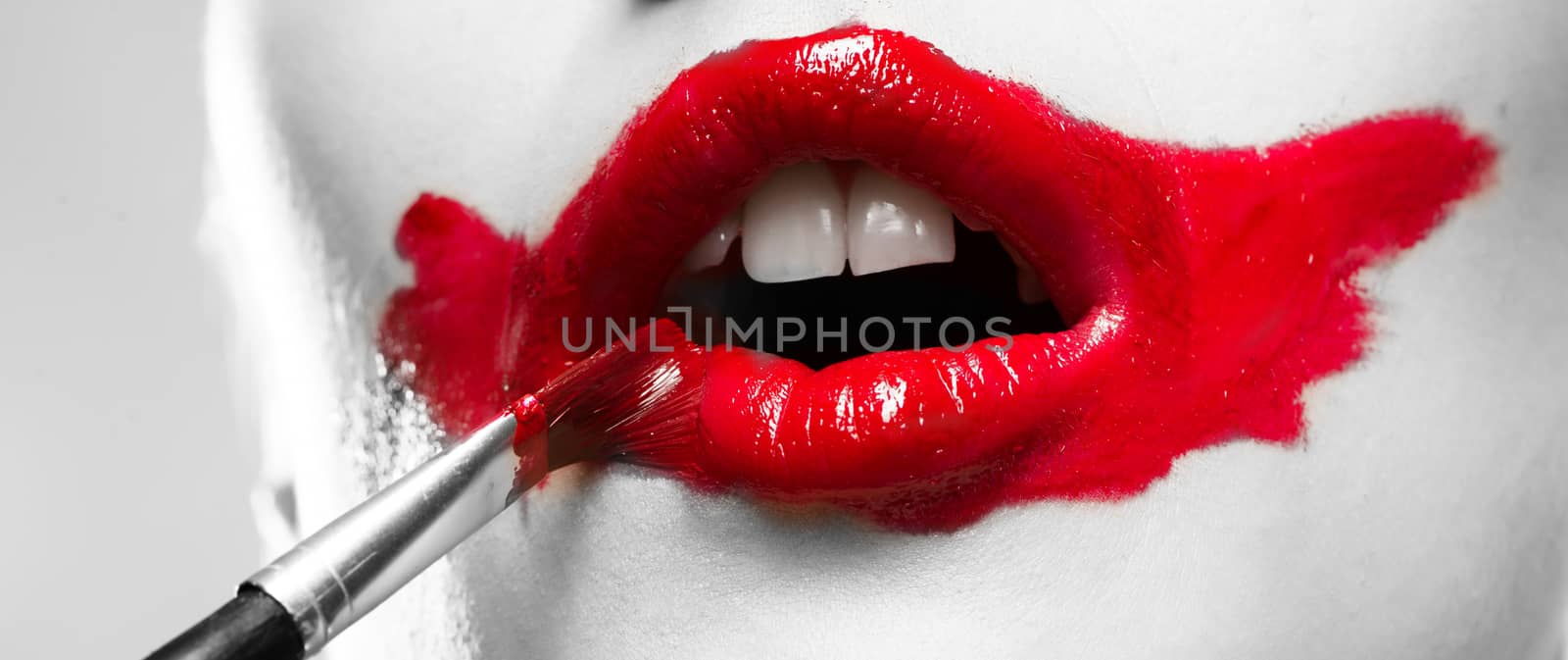 close-up of a female vivid red mouth, conceptual black and white image