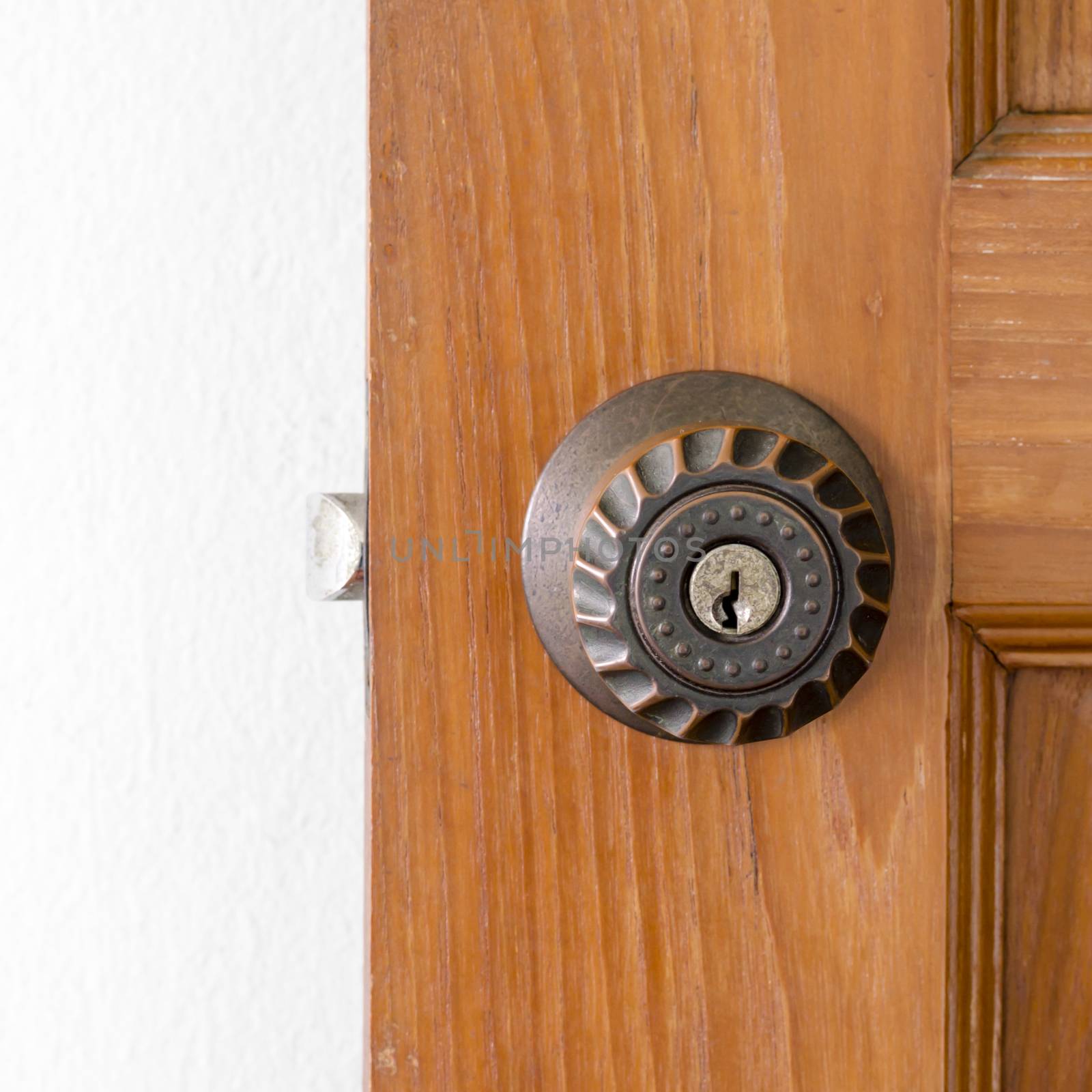 door knob and key hold on wood