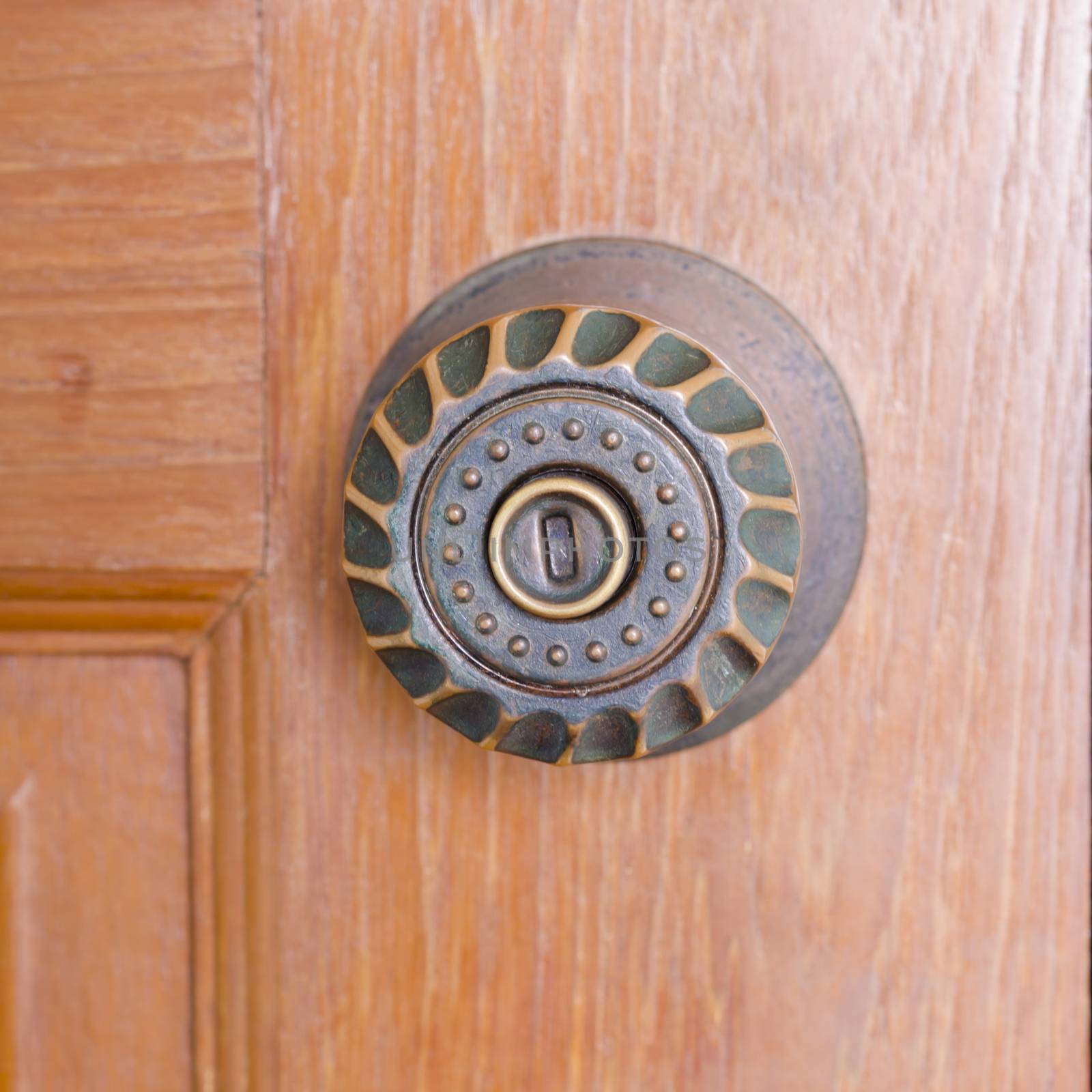 door knob and key hold on wood