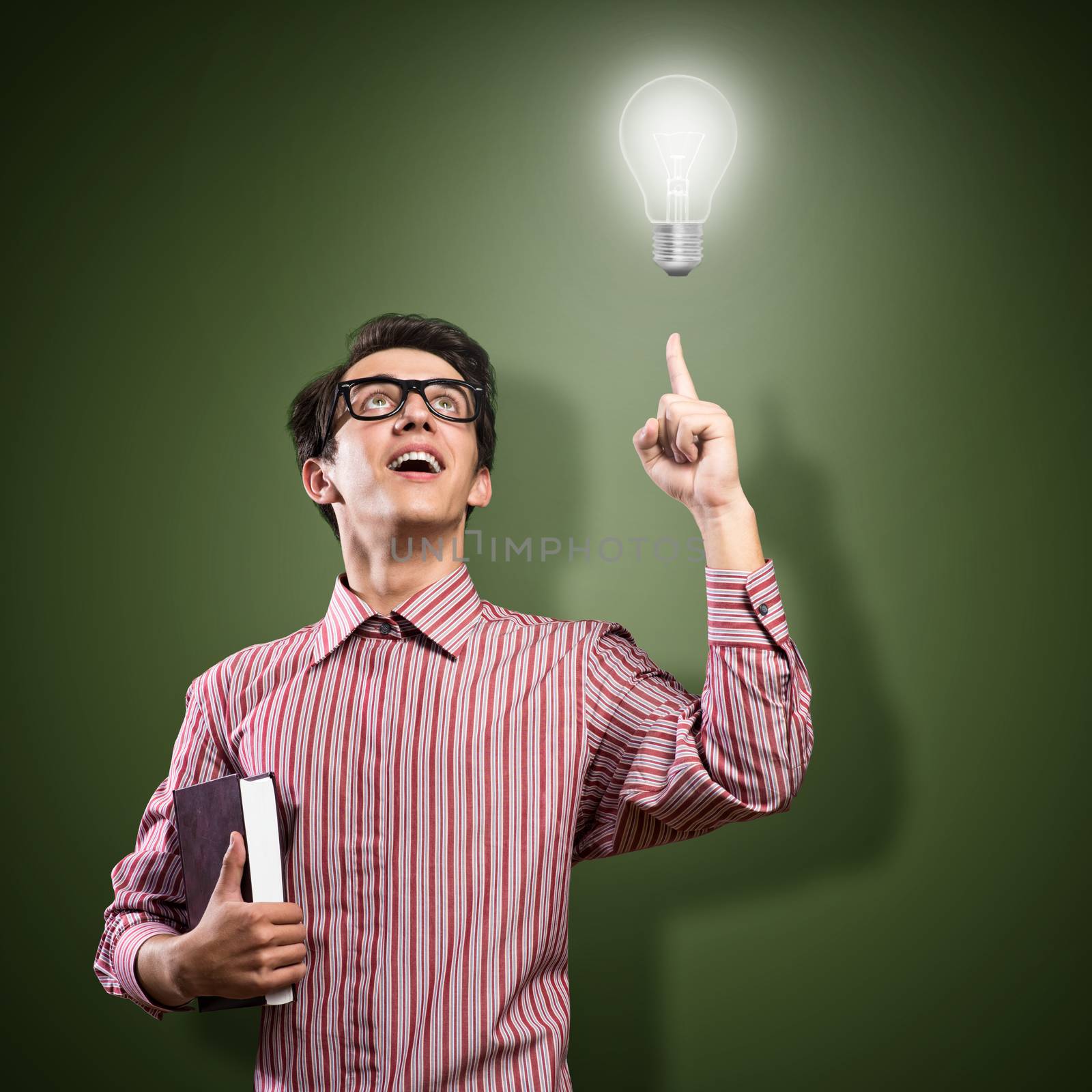 young man holding a book in front of him, raised his hand, the idea