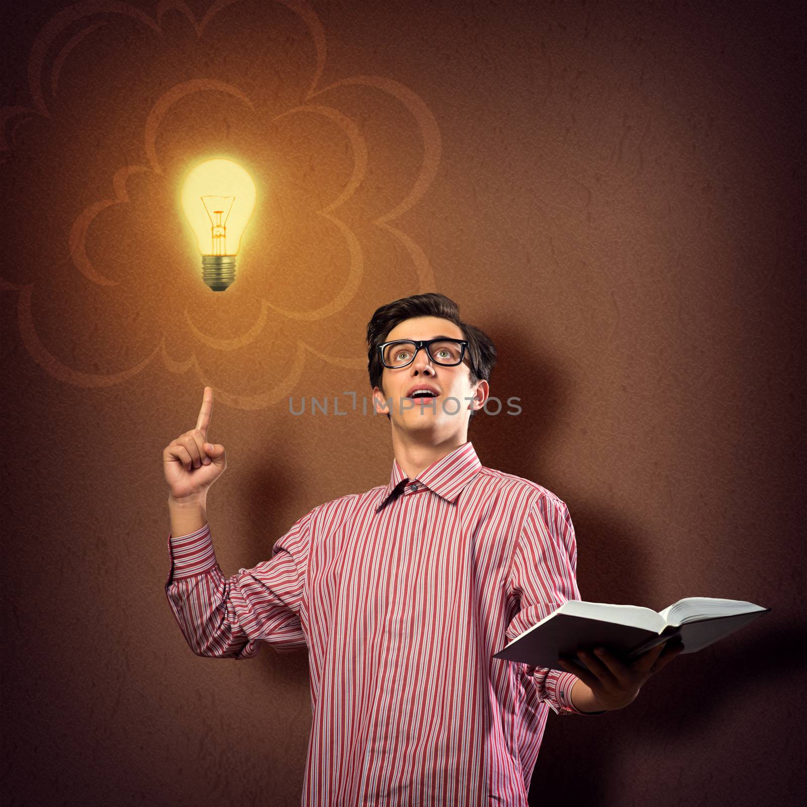 young man holding a book in front of him, raised his hand, the idea