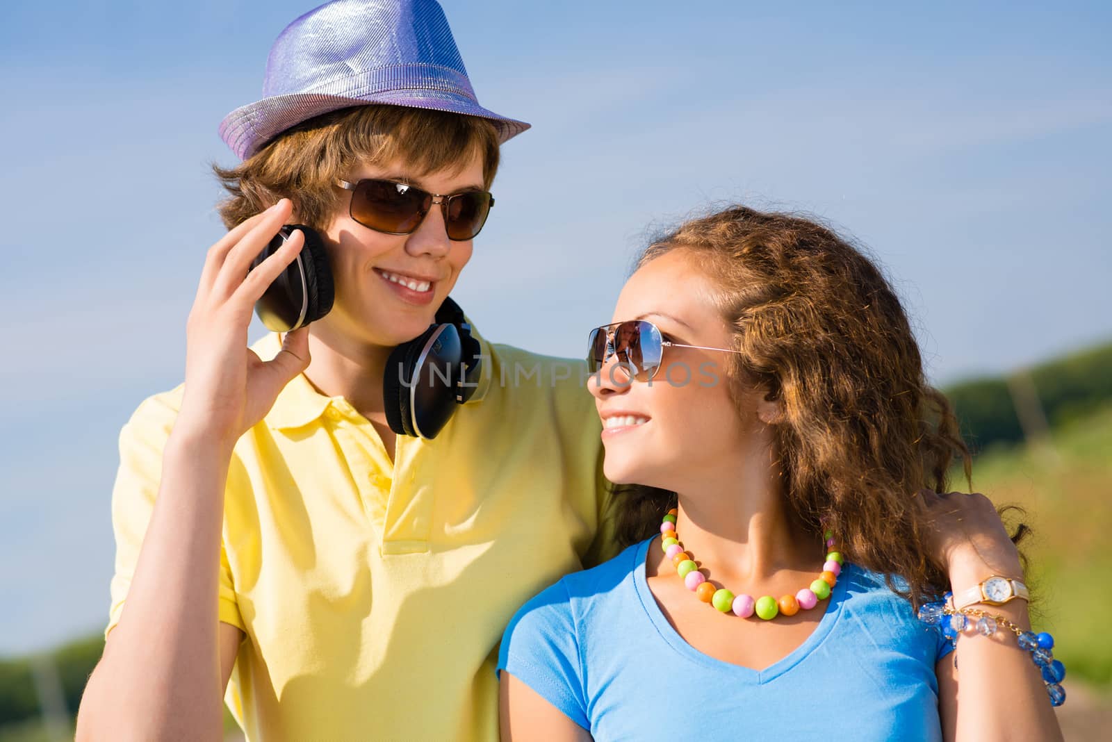 young couple standing on the road, having fun with friends