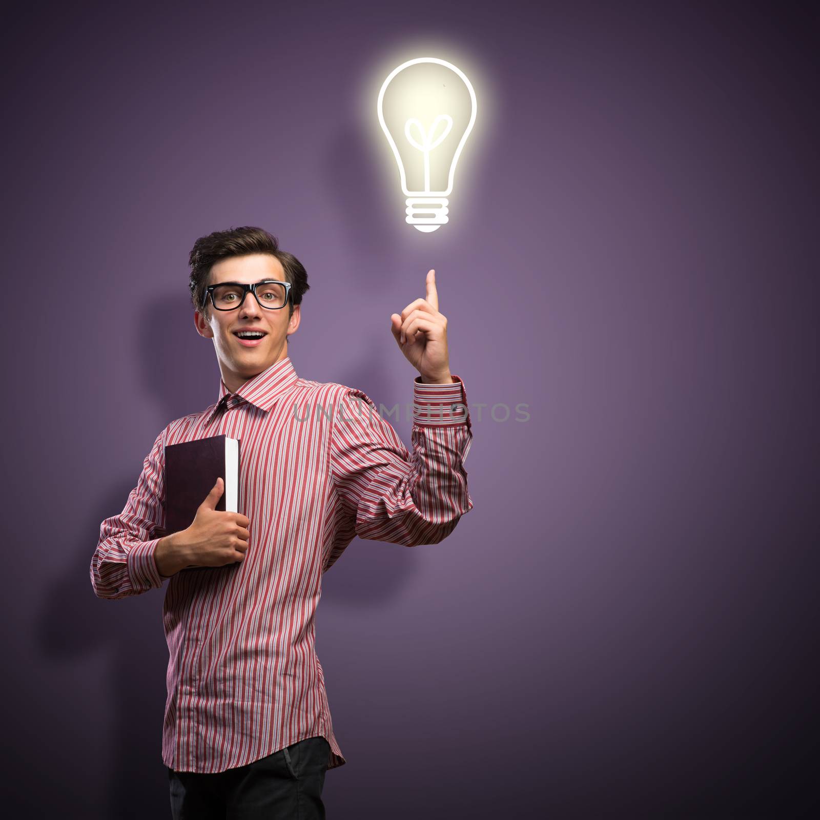 young man holding a book in front of him, raised his hand, the idea